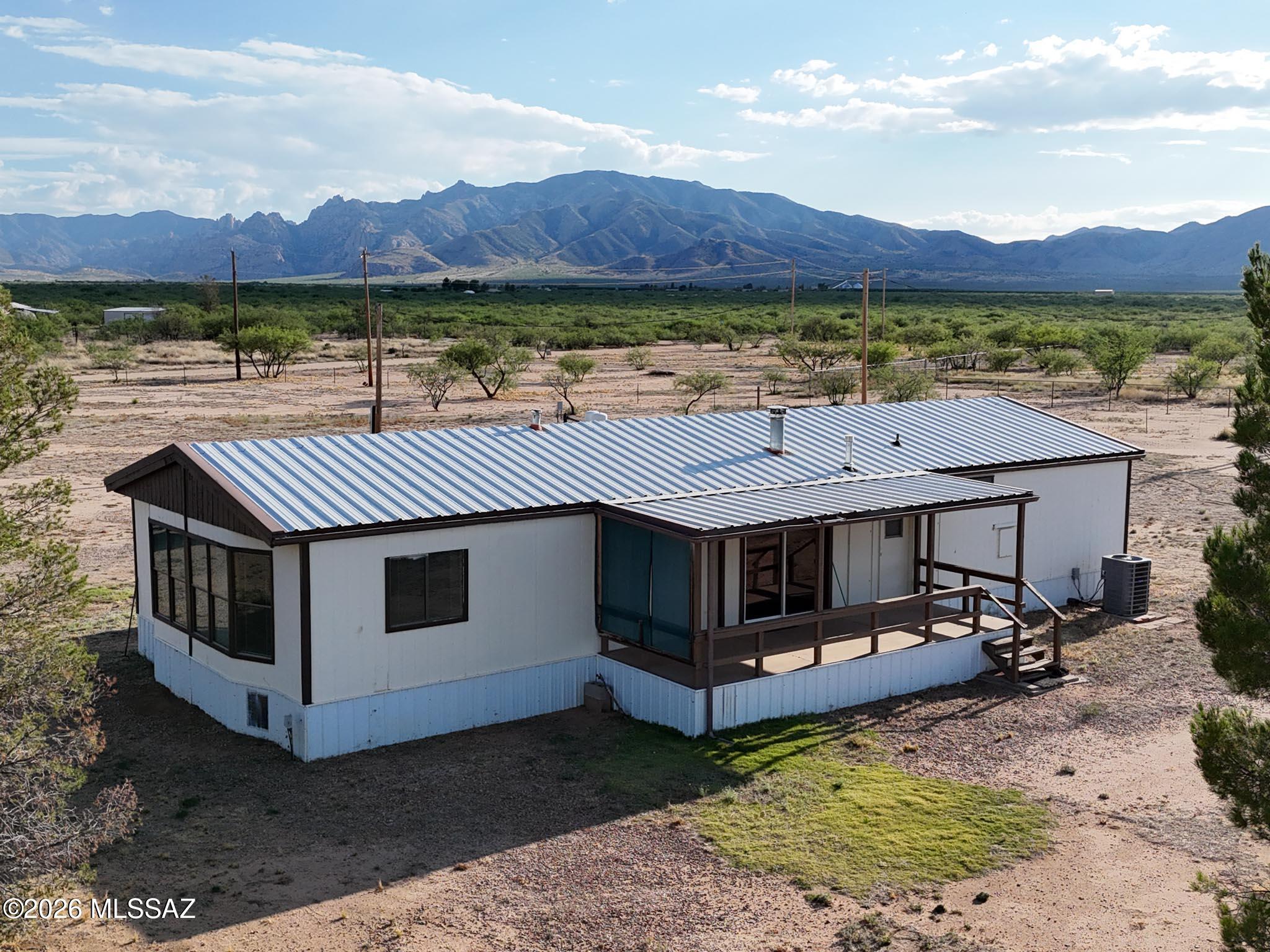2 bd/2bath on a fully fenced 5 acres. Gorgeous mountain views.  New A/C.  HUGE SHOP (1600 sq feet).  Mature trees.  Horse facilities.  Private, registered well.  Metal roof.  New flooring on the front deck.  Note: LA is related to seller.