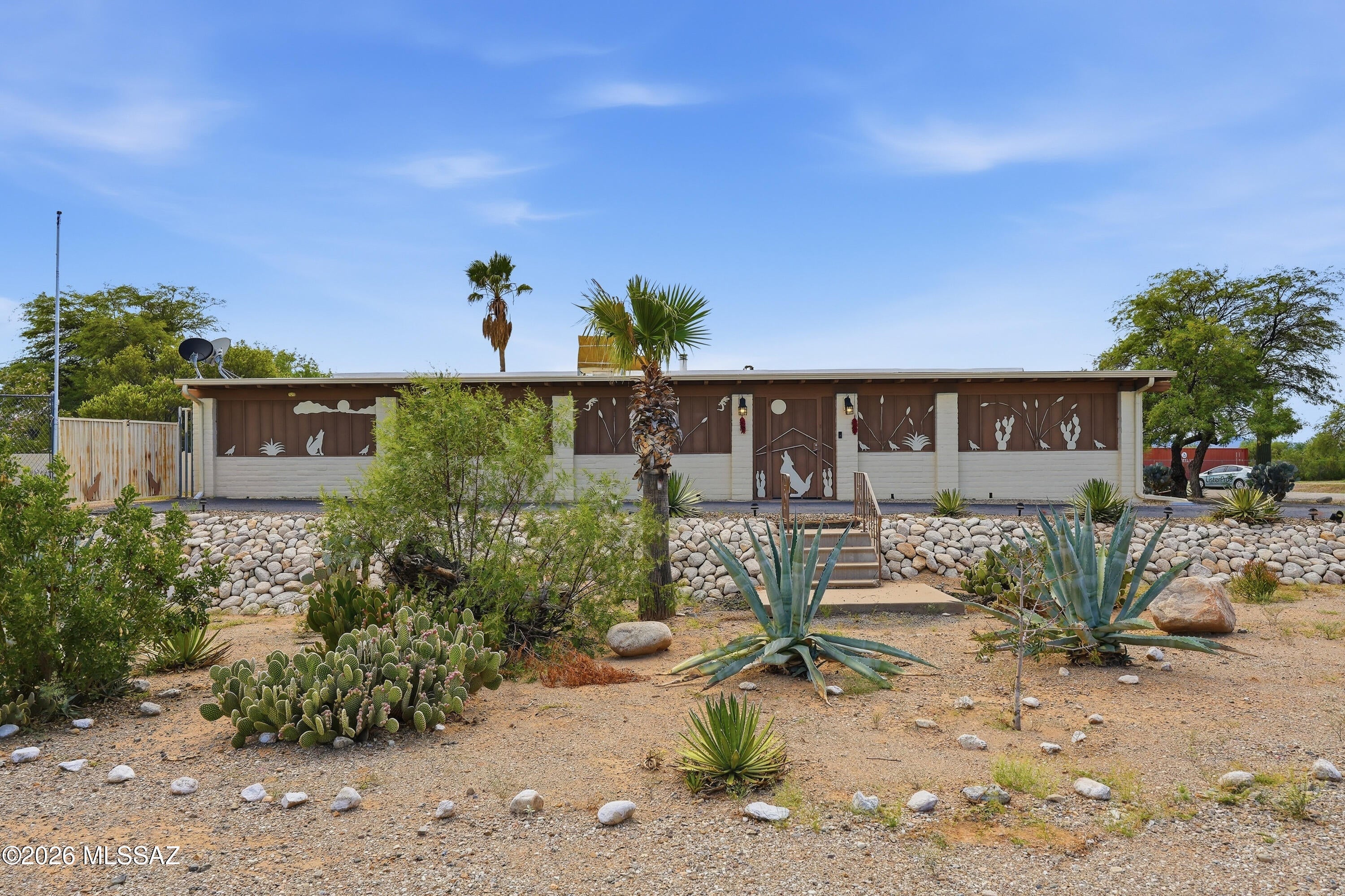 Set on a private 1.1-acre corner lot in San Joaquin Estates, this spacious 2-bed, 2-bath home offers peaceful desert living with panoramic mountain views. The 1,536 sq ft interior features a comfortable living room, office space, and an inviting kitchen with gas range, dishwasher, microwave, and breakfast bar. A wood-burning stove adds warmth and charm. Step outside to enjoy the expansive natural desert landscaping, covered and enclosed patio spaces, and your own in-ground conventional pool--perfect for cooling off under Tucson's sunny skies. With room for RV parking, fenced yard, this property blends practicality with serene rural appeal. A rare opportunity for privacy, space, and outdoor enjoyment.