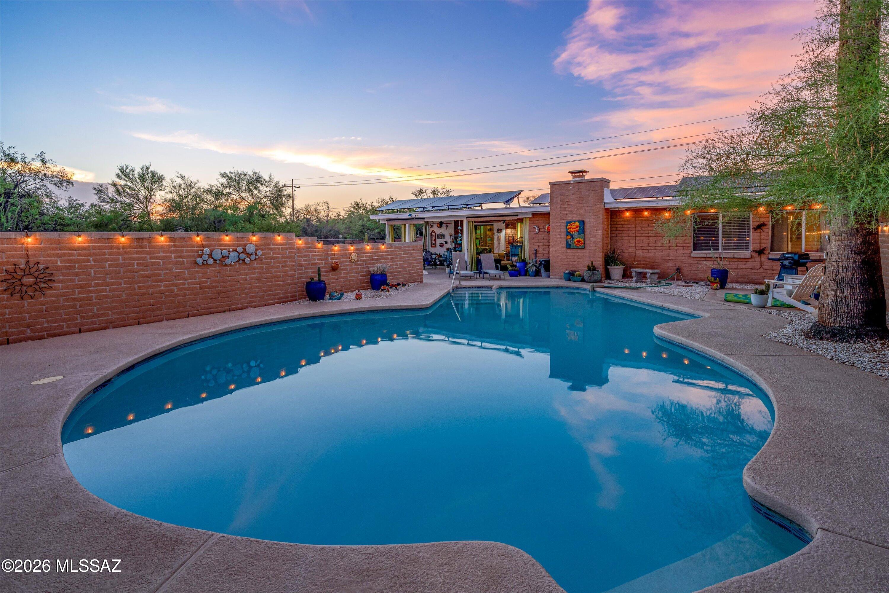 NO HOA * Guest House * Pool * Owned Solar * RV Hookups * 4 Garage Spaces! This exceptional 3-bed 2-bath 1,980 sq ft main home & 600 sq ft guest house sit on .82 acres in a peaceful community where homes rarely become available. Enjoy breathtaking views from your fully enclosed backyard oasis w/ solar-heated pool, covered patio & easy-care desert landscaping. The primary suite features a double vanity & spacious California Closets dressing room. Neutral tile, dual-pane windows, a bright kitchen w/ new stainless appliances & a laundry room w/ abundant cabinetry make everyday living effortless. Newer HVAC, tankless water heater & owned solar provide added comfort & energy efficiency. The guest house (''Sage Cottage'' on Airbnb) is a fully equipped 1-bed 1-bath retreat ideal for..... .....multi-generational living or as a turnkey income-producing rental. Close to schools, medical facilities, shopping & dining. Be sure to review the attached Upgrades & Features List--there's simply too much to mention!