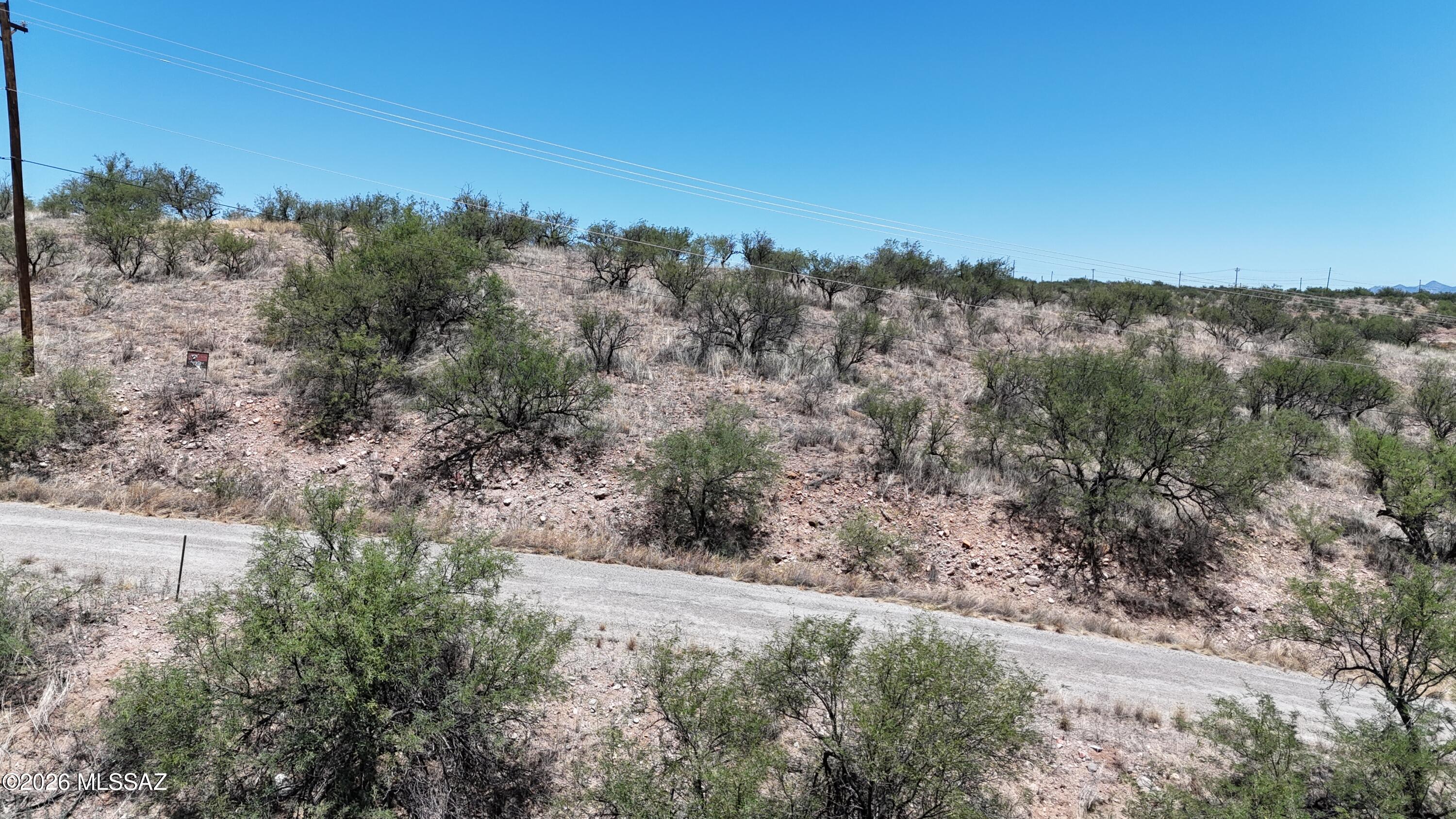 Build on this ridge line lot and have a view all the way to Tucson.  Passed a percolation test in May 2026.  Electric and water at the street.  Owner is gathering all other useful information to share with a buyer such as a grading quote & tap quote.