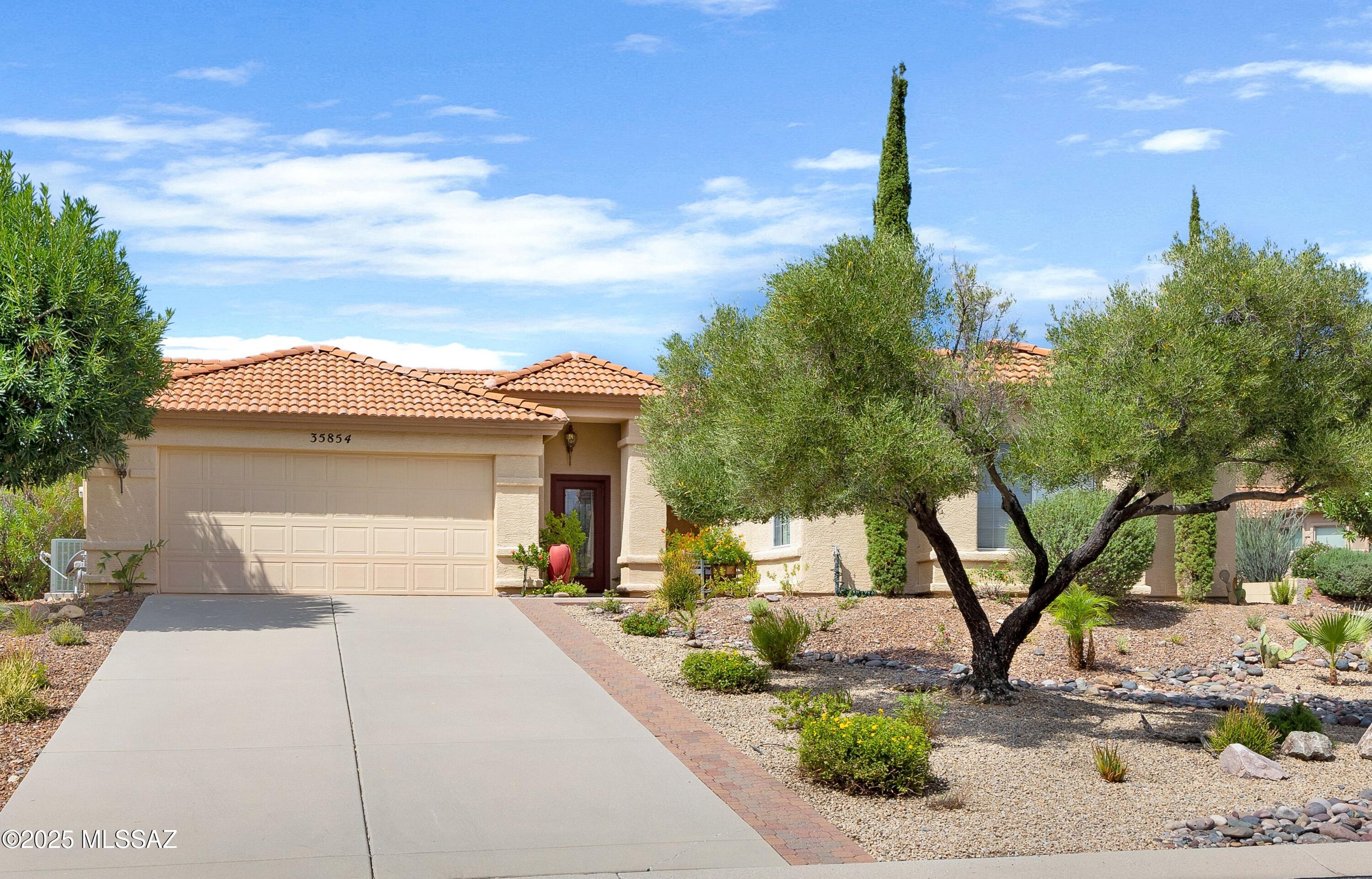 35854 S. Wind Crest Drive is a rare SaddleBrooke property that sits back from the street on a large corner lot with spacious gardens & mountain views, surrounded by a hedge that affords total privacy. The property consists of a main house with a Great Room with French doors to adjacent covered sun room, dining room, kitchen with stainless steel appliances, granite counter tops, a large flex room that can be either a den, office or bedroom, a large master bedroom with French doors to patio & two full bathrooms, in addition to a separate casita, entered from across the front courtyard, with a large bedroom, kitchenette & full bathroom.