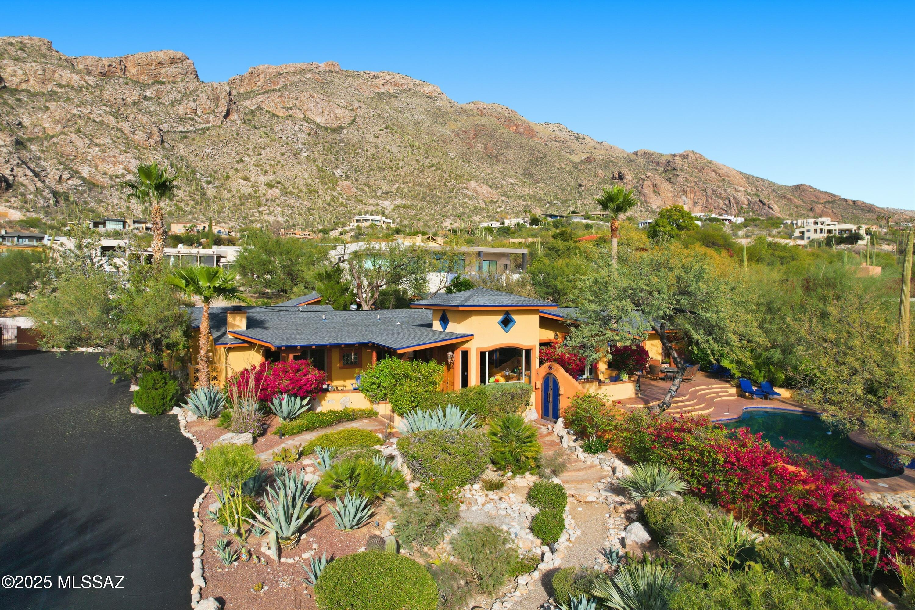 Experience quintessential Southwest living in this exceptional Tucson estate, offering a stunning blend of comfort & character. 4-bedroom, 5-bath + office main house features a split floor plan, authentic Saltillo tile, & colorful finishes. Striking 2-sided fireplace warms both family & living areas. Primary suite is secluded w/a cozy kiva fireplace & private patio. The stylish yet functional kitchen opens to dining areas which flow easily to the outdoor covered patios. Resort-style yards create a desert oasis showcasing mature vegetation, featuring a luxurious pool & spa w/an endless view backdrop, separate casita, studio w/sauna & relaxing waterfalls. Roofs replaced in 11/25. Convenient yet private location at the top of Swan w/ A+ views!  Near shopping, dining, schools, hiking, and more