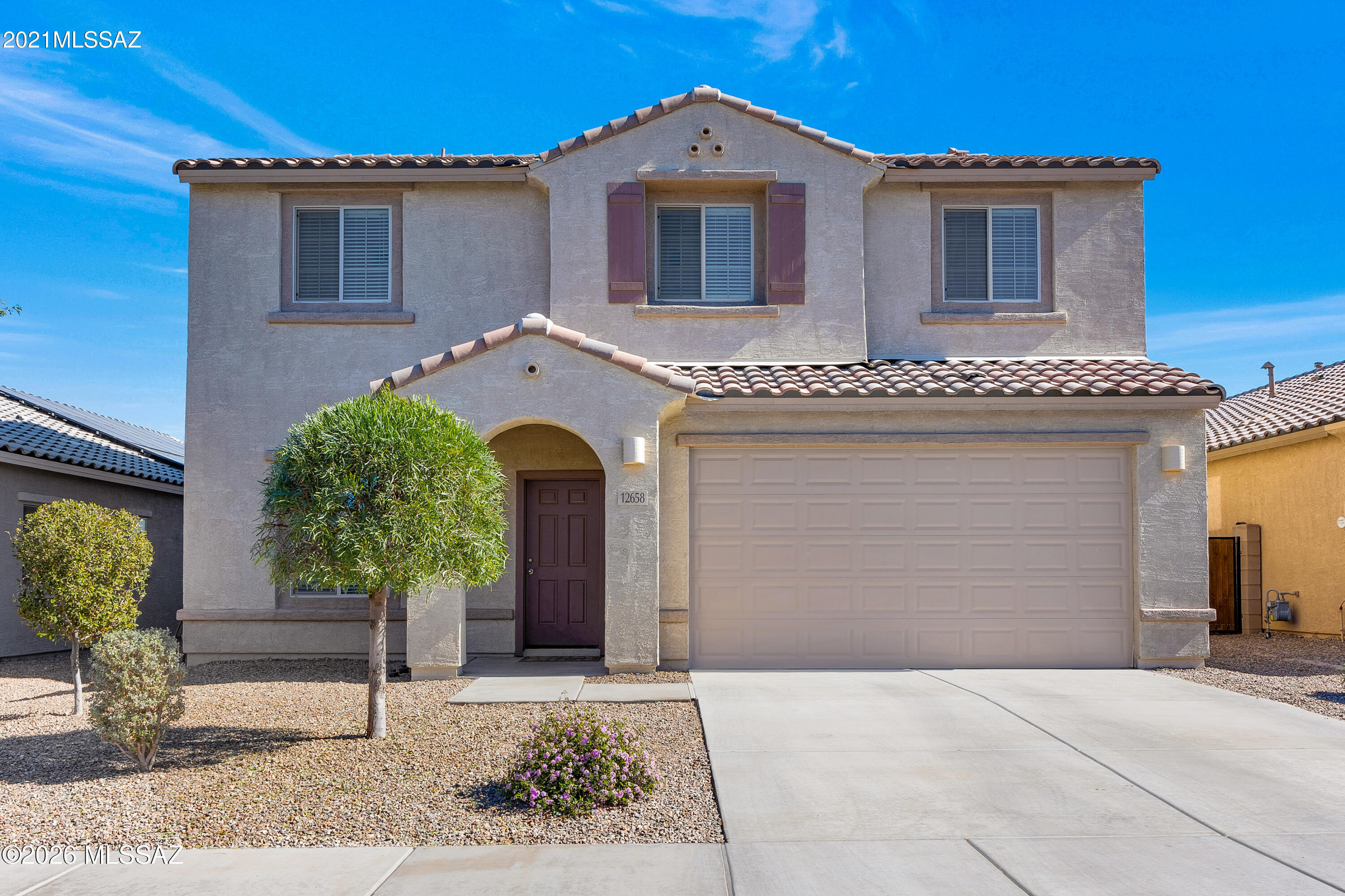 Beautiful two-story home located in the highly sought-after Gladden Farms community! This 4BR/3BA home features a bonus room/den with double doors and a half bath downstairs, plus an open-concept living, dining, and kitchen area. The kitchen offers granite countertops, island, stainless steel appliances, cabinet hardware, closet pantry, and large under-stair storage. Tile flooring in the kitchen, bathrooms, and laundry room. Upstairs includes a loft, three bedrooms, full bath, and a spacious primary en-suite with dual vanities and an oversized L-shaped walk-in closet. Enjoy a covered patio and fully landscaped backyard with pavers, gravel, and mature fruit trees. HVAC and tankless water heater approx. 3 years old. Enjoy the lifestyle Gladden Farms offers with exceptional neighborhood amenities nearby. Conveniently located within walking distance to Fry's Marketplace, shopping, and dining. Outdoor recreation is just minutes away at Heritage River Park and Gladden Farms Community Park, featuring playgrounds, sports fields, ramadas, dog park, and a popular splash pad. The nearby Marana Aquatic & Recreation Center (MARC) provides pools and family-friendly aquatic fun. Miles of walking and jogging paths connect parks, schools, and everyday conveniences for an active, connected community lifestyle.