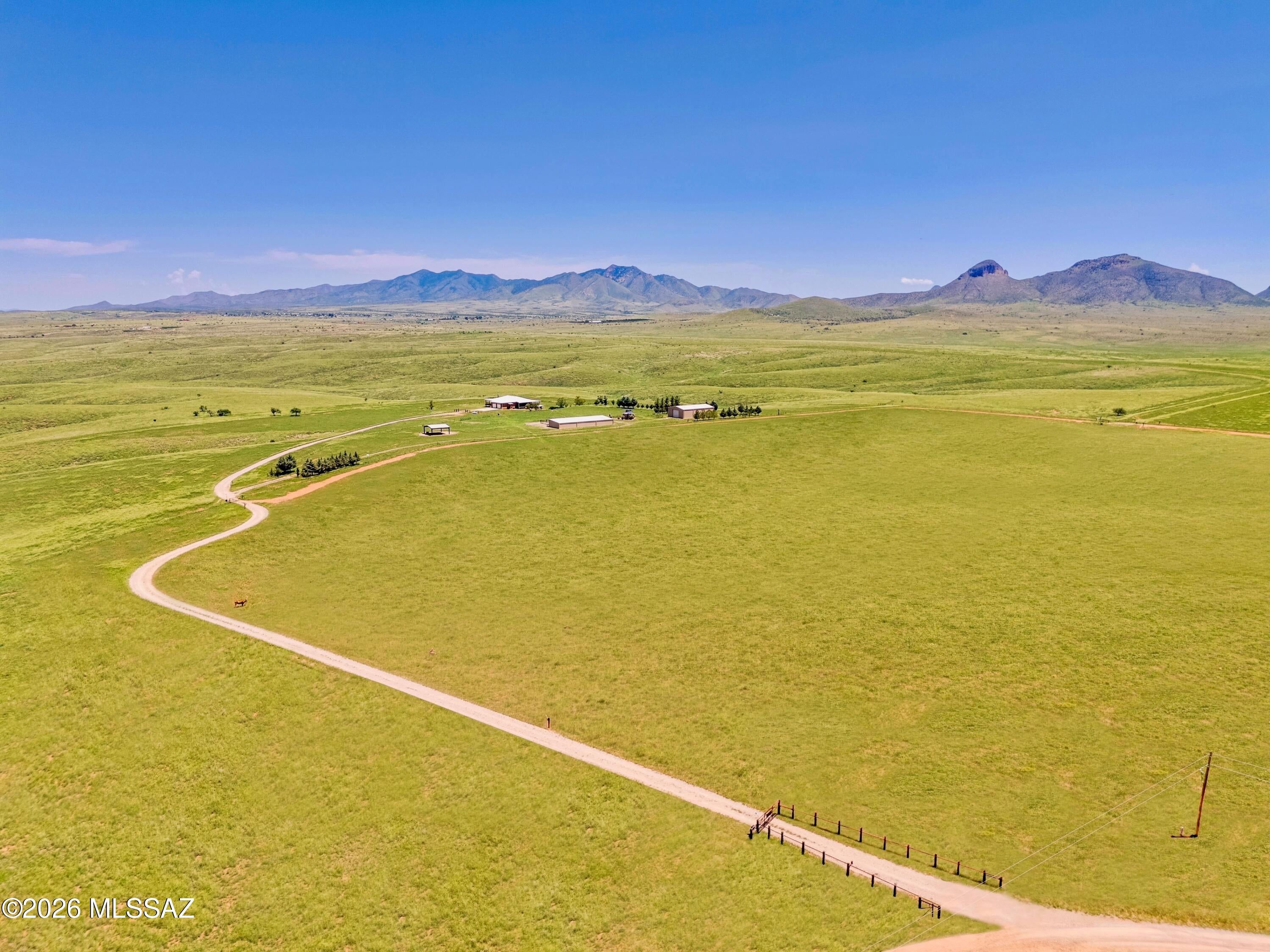 Unique Opportunity | Southern Arizona Ranch Estate in the Heart of Elgin Wine Country. Discover a rare legacy property on approximately 36.81 private acres in the heart of Southern Arizona wine country. This exceptional Elgin, AZ ranch adjoins Arizona State Land, placing horseback trail riding, hiking, and mountain biking right outside the gate. Unobstructed valley and mountain views create an extraordinary backdrop for a property built to be enjoyed, stewarded, and passed from generation to generation. The permitted improvements include a 2,304 sq. ft. single-story residence, a 2,412 sq. ft. metal storage garage, a 750 sq. ft. metal hay shed, and a 2,200 sq. ft. stable--an exceptional foundation for an equestrian lifestyle, country retreat, or enduring Southern Arizona estate. Two wells and power running the length of the property support the acreage's remarkable potential. All buildings have county permits and final inspections. With numerous potential residential building sites and the ability to be split into two approximately 18-acre parcels, the property offers room to shape a private compound, create space for guests, or plan thoughtfully for the future. Excellent drainage enhances the usability of the land. Surrounded by the rolling landscapes, vineyards, and tasting rooms of the Sonoita-Elgin wine region, this is Arizona acreage for sale with uncommon privacy, recreation, views, and vision.