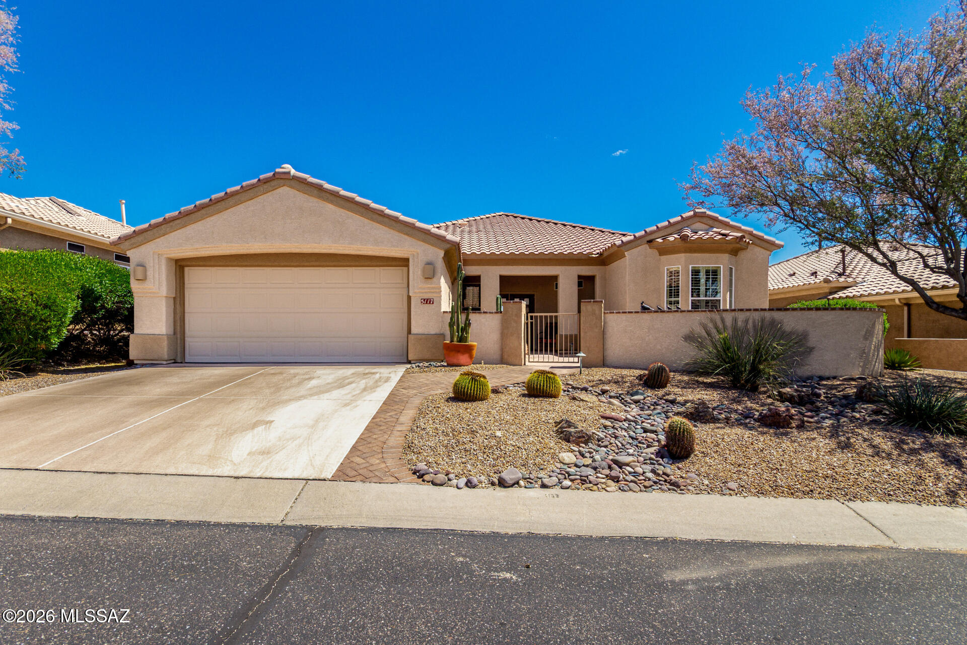 Welcome to this immaculate Santa Rosa  home in the prestigious Highlands at Dove Mountain, where breathtaking golf course, city lights, and mountain views greet you every day.  Featuring 2 oversized bedrooms, a den with a built-in Murphy bed and a spacious great room with walls of windows dressed in gorgeous plantation shutters that flood the home with natural light. Bay windows in the dining area, primary, and guest bedroom frame the incredible views, while the natural habitat buffer along the 9th Tee provides wonderful privacy. The updated bathrooms, extended laundry room, new Lennox HVAC (2024), newer hot water heater, new irrigation system, and electronic rolling shutters make this home truly move-in ready. Outside, a large front paver courtyard and extended back paver patio offer the perfect spots to relax and soak in the amazing scenery. Great opportunity to own a spectacular, spacious home with  some of the best views in town! Best of all, life at the Highlands at Dove Mountain comes with an incredible lifestyle - enjoy 24-hour manned security, an award-winning golf course, pickleball, tennis, billiards, a beautiful restaurant and bar, pool, hot tub, and a wonderful array of social activities and clubs that make it easy to connect with neighbors and friends. Plus, with scenic hiking and biking trails nearby, outdoor adventure is always at your doorstep. This is a rare opportunity to own a spectacular, move-in ready home in one of Dove Mountain's most sought-after communities! Furniture  is available to stay!