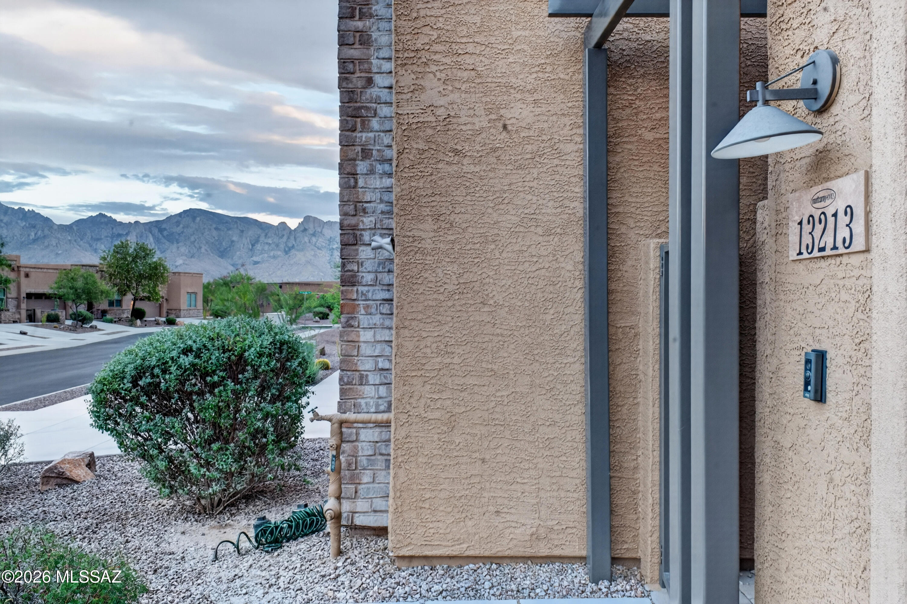 Two private spaces, one gated Oro Valley address. Built in 2019 & wrapped in mountain views, this 1,802 sq ft home pairs a single-level main house with a fully separate casita - a genuinely flexible setup for guests, a home office, a studio, or added income potential. The main house centers on a spacious primary suite & a versatile den with 10-foot ceilings, plantation shutters, & ceramic tile throughout. The open kitchen delivers an oversized granite island, gas cooktop, reverse-osmosis system, & ample storage while the primary suite includes ADA adaptations & a ramp for step-free access. Step outside to a welcoming front courtyard & a landscaped, low-maintenance backyard built for easy lock-and-leave living. Behind the gates, residents enjoy a community pool, spa, BBQ area, & green space just steps away, plus a 2-car garage -- and the HOA takes care of roofing, exterior paint, & front yard upkeep, keeping true lock-and-leave living. Foothills views, single-level ease, and a flexible casita -- minutes from Oro Valley's golf, hiking, dining, and shopping.