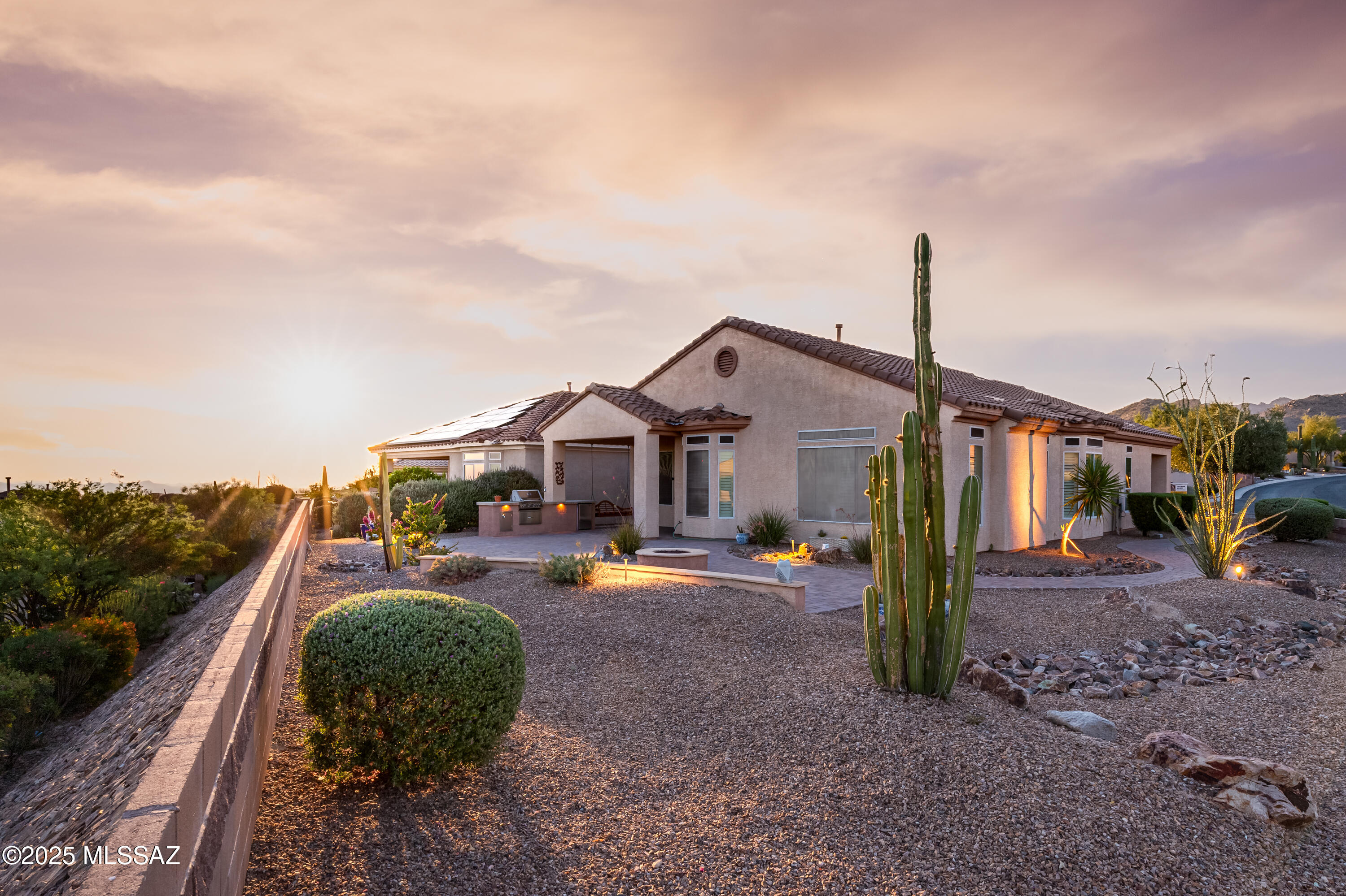 Stunning sunrises, sunsets, and everything in between.

Fully completed with interior paint, this beautifully positioned home sits on a large, elevated lot offering sweeping panoramic views from the east to the south and west.
Designed for both comfort and entertaining, the backyard is a true highlight, where you can take in the surrounding beauty from an expansive space featuring patio pavers, fire pit and a built-in outdoor grill, perfect for gatherings or quiet evenings under the Arizona sky.

Inside, the 2061 sq ft home offers 2 bedrooms plus a dedicated office/den providing flexibility for work or relaxation. Shutters throughout add timeless style, privacy, and energy efficiency to every room.  This home is a must see!  Call for a private showing.