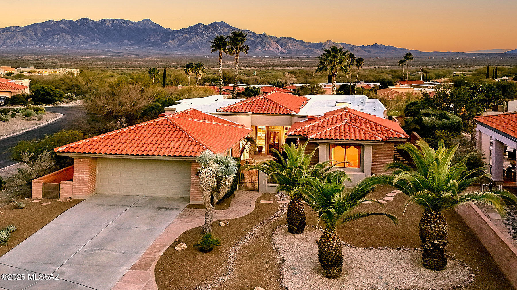 Discover the rare opportunity to embrace the ultimate desert lifestyle in this exceptional San Ignacio residence, where breathtaking panoramas and thoughtful design converge to create an unparalleled living experience. Positioned to capture one of the most coveted settings in the community, this home showcases wide-open desert vistas dramatically framed by the majestic Santa Rita Mountains. Every living space opens to this spectacular natural backdrop--a private panorama that changes with the light. Expansive windows line the rear of the home, flooding interiors with natural light and maintaining  the connection between indoors and out. The generous back patio, a masterfully designed outdoor sanctuary that invites lingering over morning coffee sunset cocktails, and evening conversations under a canopy of stars. This is where life naturally unfolds, where distinction between inside and outside gracefully dissolves. The built in BBQ encourages dining al fresco with friends, while the water feature gurgles in the background.  Inside, the magnificent kitchen was meant for entertaining and making memories with family and friends. A breakfast nook, breakfast bar and formal dining area all surround the heart of the kitchen, so the chef is always front and center, and there is plenty of room for guest overflow.  The living area is framed by breathtaking mountain views and is generous enough to accommodate a baby grand piano, a private library, or a dedicated space for the grandkids -- whatever your vision, this room can hold it. The elegant primary suite gazes out over the patio and mountains beyond, while the spa-inspired bath invites you to slow down and be truly pampered. Two additional guest suites offer exceptional flexibility -- ideal as bedrooms, a den, a media room, or a quiet home office. This is more than a home; it's a life of refined elegance and profound peace. Here, every day feels like a retreat, the desert's timeless beauty is your constant companion, and nature and sophistication exist in perfect harmony!