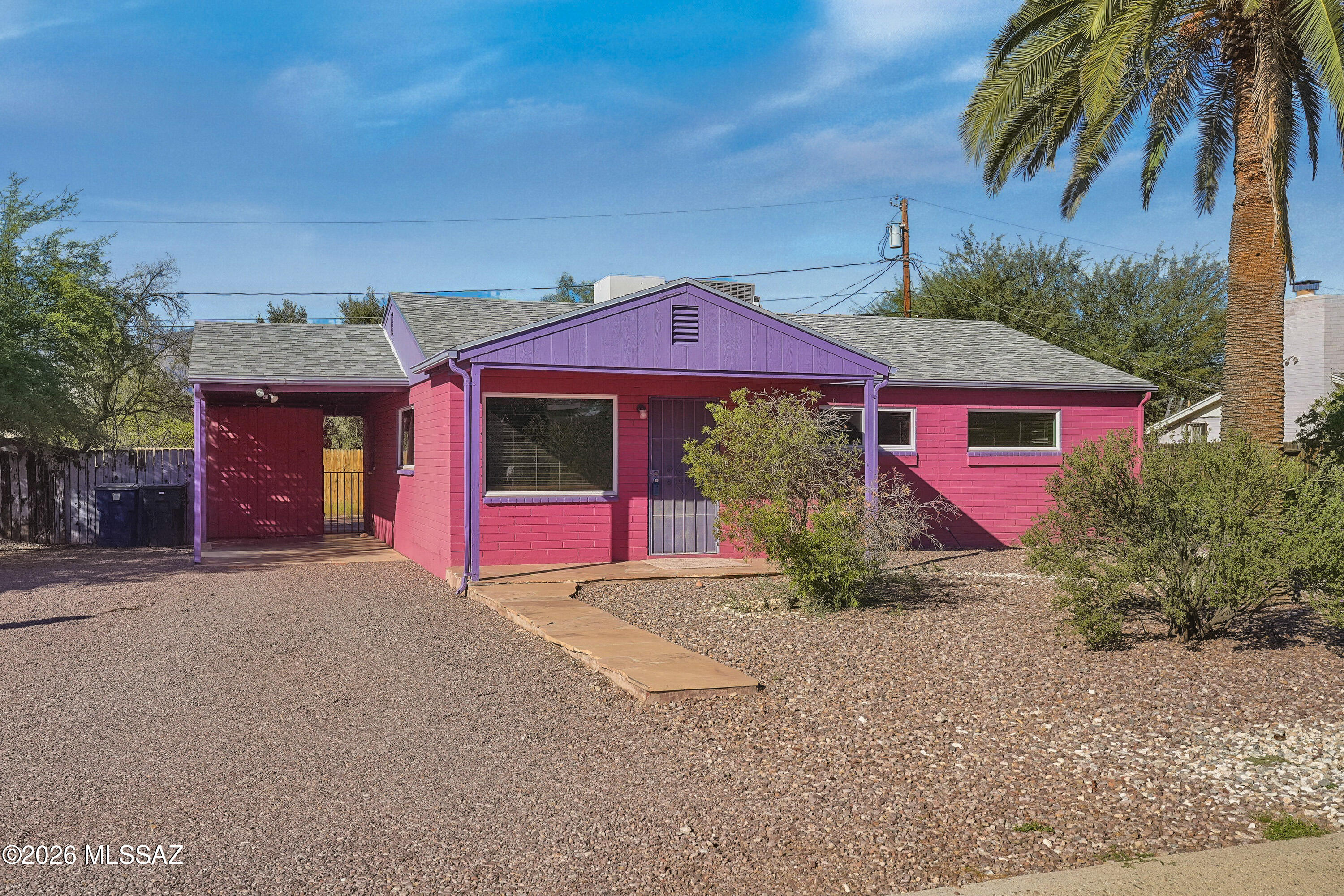 Conveniently located to TMC, restaurants and shopping this 3 bedroom/1 bath  bungalow is situated on an expansive lot with a fenced back yard.  Enjoy mature landscaping and open area in the back which has Catalina Mountain views. You might want to keep the colorful interior accents or paint to enhance your lifestyle decor.  The home has large windows which make the living areas bright.  New carpet is in 2 of the bedrooms with a wood pattern vinyl floor in the 3rd bedroom.  Ceramic tile is throughout the living, dining and kitchen. The large, covered patio faces north with mountain views.  Also in the rear yard is a small metal shed for storage and a laundry shed with washer and dryer and room for more storage.  If you love the convenience of central Tucson living, you'll love this home!