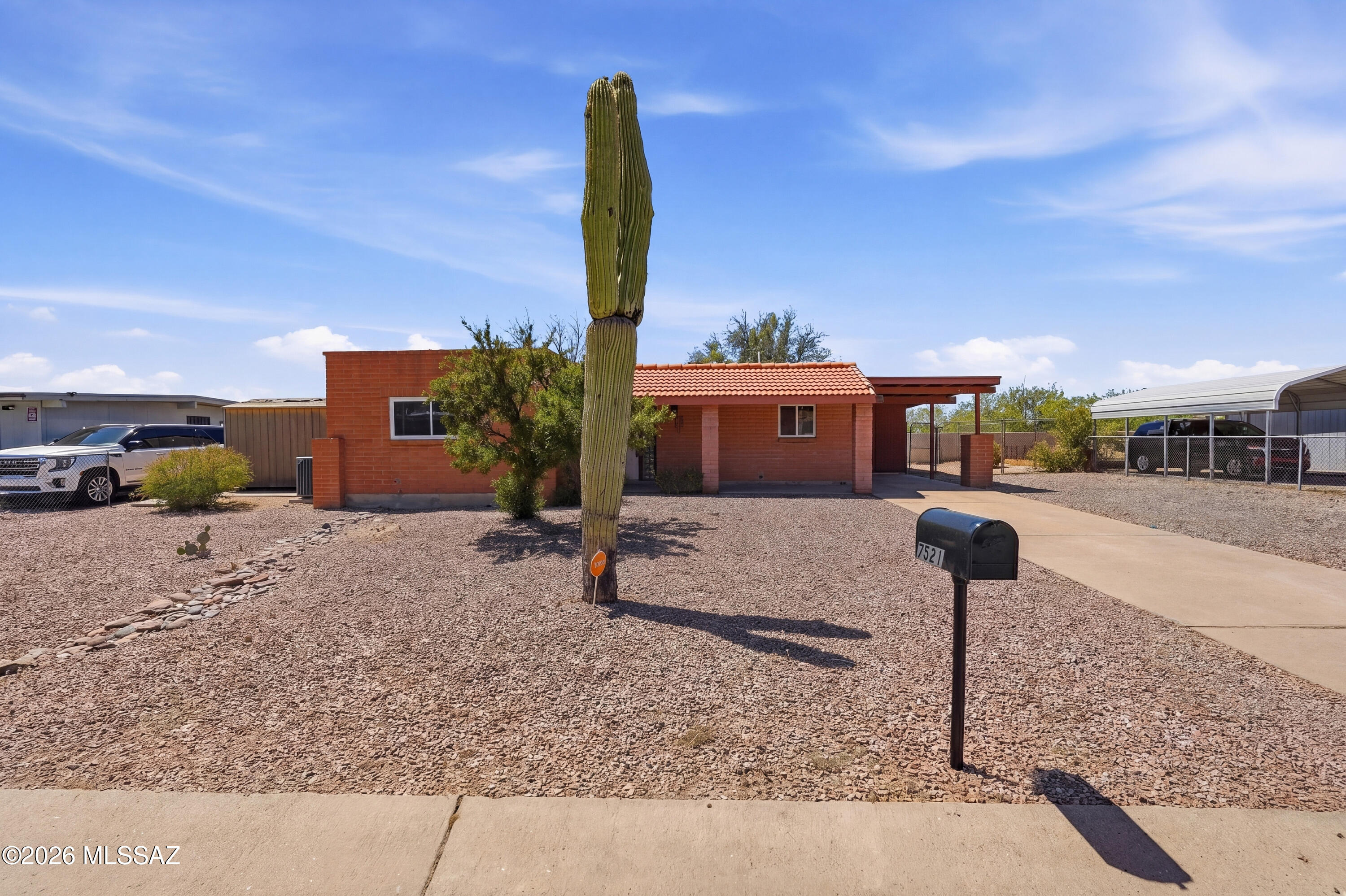 Less than a mile from all your shopping and service needs to the intersection of Ina and Thornydale.  The home is situated in a mature and stable neighborhood, no HOA, full masonry reflecting pride of ownership.  Across the back of the home is deep full length covered patio looking to the Tucson Mountains.  The lot is 8328 sq. ft. so there is plenty of yard surrounding the home.  The home features scored concrete flooring and carpet in the bedrooms.   The windows are vinyl clad dual pane.  The back yard provides opportunity for all types of uses and there could be a large gate leading into the rear yard.  There are additional updates and all appliances are included.
