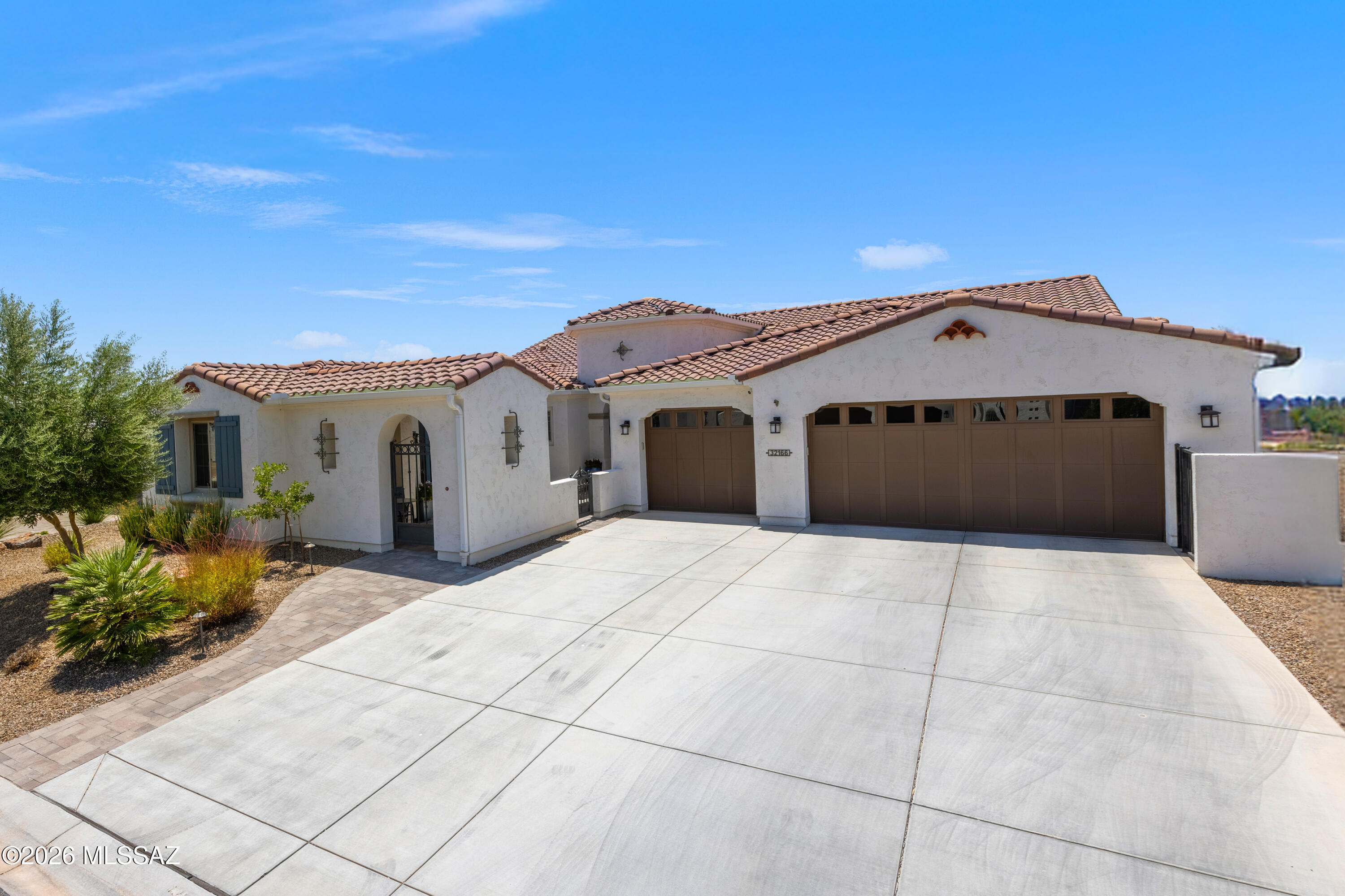 A Stunning 2,855 Sq. Ft. Tesoro Model Exterior Design A with an attached Casita and desert views with incredible Sunset Views! 3-Bedroom En Suites (this includes the incredible optional attached Casita w/separate access and a beautiful Portico entrance); Powder Room; Great Room w/Media Alcove and optional 16080 Stackable Sliding Glass Door + Surround Sound; Dining Area w/''Doggie Door''; Grand Kitchen Island w/Butler's and Walk-In Pantry, hot water tap at kitchen at Blanco Sink, a trash compactor; Spacious Den/Office w/Optional 3' extension and barn door ; 2-Walk-In Closets in the Primary En-Suite w/the expanded Walk-In closet, and alternate Primary Bath option, and optional 2'' extension; Entry Valet w/base cabinets; Walk-up Dry Bar; Large Laundry Room; Optional 3-Car Garage w/Tankless water heater, and filtration system, and "Gorilla" Racks and a high-end "work bench" that conveys with the sale:; Walk-In Coat Closet; Walk-Up Dry Bar; Large Laundry Room w/sink; 220 Sq. Ft. Outdoor Living Space w/Outdoor Living Space "A" w/Television circuitry installed and attached Pergola outside Dining Area, 9' and 11" Foot Ceilings through-out the home. The Backyard is fully fenced, landscaped, and irrigated and includes a Built-In BBQ Kitchen w/Seating, portable Traeger Smoker, a beautiful water feature, Detached Pergola with a swing for 2-people, a wood burning fire pit, and to "top it all off" Tucson Rolling Shades! The interior of the home starts with a "high-end" iron front door that opens up to let the cool winds to come into the home without reducing security; upgraded Built-Ins throughout the home; and most of all, shades in the home are motorized with variable shading/privacy. Let us talk about the Casita: there is an up-graded GE "Café" 2-drawer refrigerator, Wet Bar, and upgraded Built-Ins.
