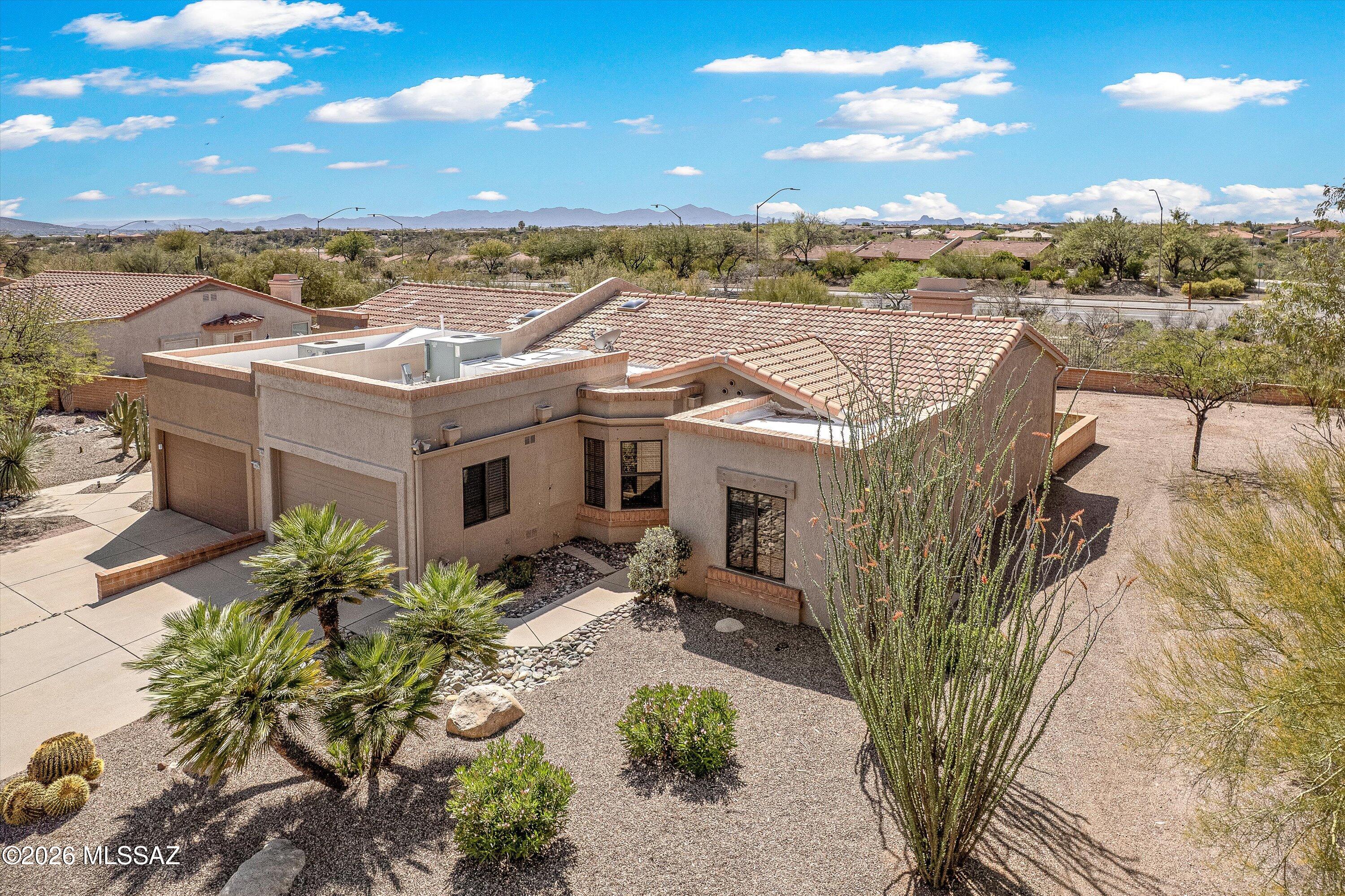 Impeccably maintained 2BD/2BA (1,308 sq ft) townhome in Sun City Oro Valley's 45+ community offers privacy and tranquility plus views of the Catalina and Tortolita Mountains. Can be purchased furnished! Step inside this contemporary, move-in ready Bolero model situated on a spacious lot toward the end of a cul-de-sac street. Enjoy effortless living and entertaining with a split bedroom floor plan and open concept living/dining room with cozy fireplace and built-in buffet. Sleek chef's kitchen with breakfast nook bay window has been tastefully updated with granite counters & backsplash, stainless appliances and rich hued cabinetry. Luxurious Primary suite with bay window offers a dual sink granite-top vanity, tiled walk-in shower, skylight and spacious walk-in closet. Front guest room adjoins hall bath. Laundry room lies off extended garage with epoxy coated floor, work bench and storage closet. Relax on the covered, rear patio with extended pavers. Beyond lies an enclosed yard ready for an additional patio, pool or recreation area. Perfect for full-time or seasonal living! All furnishings available on separate Bill of Sale ($9,500). Seller financing available. Residents of Sun City Active Adult Community enjoy resort-style amenities including golf, tennis, pickleball, swimming, fitness center, dining and a vibrant calendar of social activities.