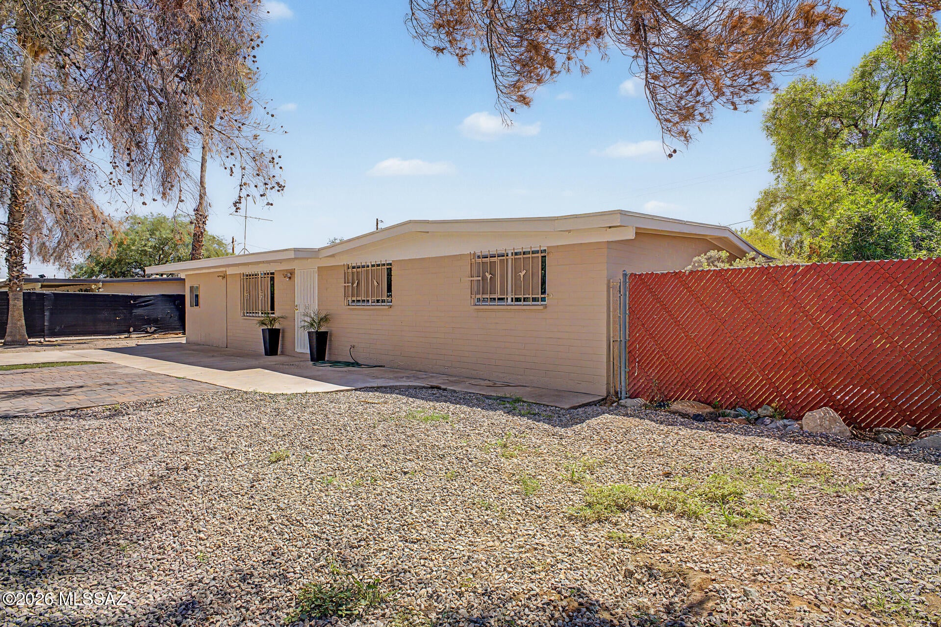 This 5 bedroom ranch style home has immense curb appeal with private gates. It sits on an extra large lot featuring top-to-bottom updates including new HVAC, roof, plumbing, electrical, double pane windows, custom tile, light fixtures, appliances, paint inside and exterior. LIKE NEW. A bright & spacious, open layout that connects an extra large family room, with vaulted ceilings dining area, and freshly remodeled kitchen The primary suite features a large walk-in closet and ensuite bath. A split floor plan provides added privacy. Outside boats a separate workshop and extra long driveway  to accommodate multiple cars.  Owner/agent