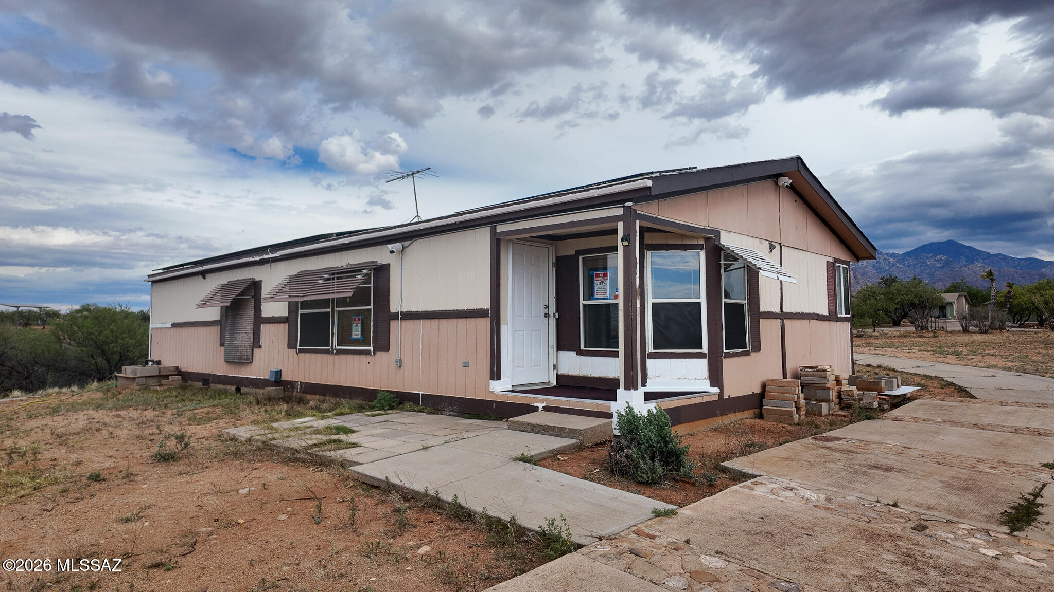 Discover a true fixer-upper gem in the peaceful community of Amado! This mobile home is ready for your complete renovation on an exceptionally great lot. Take advantage of the breathtaking views of Elephant Head and transform the property into your ideal home - the options are limitless! Nestled in tranquility, it's the perfect spot to create your dream. The well is shared with only one other residence, providing reliable water without complex sharing arrangements. Plus, the home features solar panels, making your utilities cost-effective and eco-friendly! Whether you're an investor or creative homeowner, this is your chance to build something special. Don't miss out - reach out today to explore this Amado opportunity!