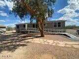 NICE MOVE IN READY MANUFACTURED HOME WITH LAND.  RECENTLY REMODELED BATHROOM SHOWERS, NEWER VINYL PLANK FLOORING, GREAT VIEWS FROM EVERY WINDOW.  
Full ramp to property installed at the front entrance of home.  
Come and see and make an offer on your new home surrounded by natural desert.