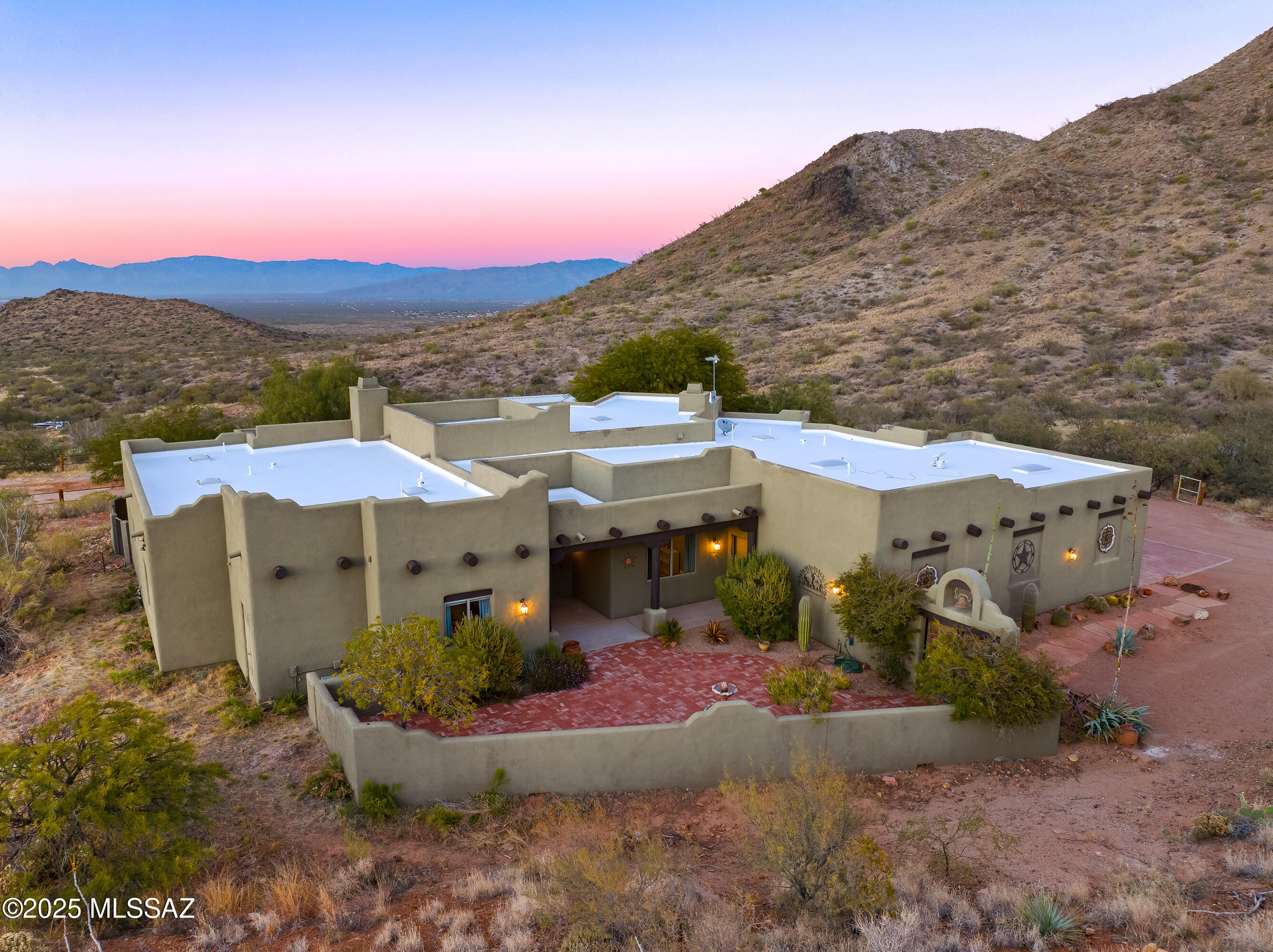 Range Pricingj:  Seller will accept or counter offers between $725,000-$750,000. Perched on top of the mountain with sweeping, miles-long city-light and mountain views, this one-of-a-kind custom home offers unmatched privacy and cooler temperatures at over 4,000 ft elevation. Set on 4.99 acres in the foothills of the Santa Ritas--and within the highly coveted Vail School District--this property delivers the rare blend of true rural living and modern comfort. Inside, picture windows frame the breathtaking panorama from the great room, dining area, and cozy fireplace. The spacious kitchen features granite countertops, double ovens, and a walk-in pantry, perfectly designed for both everyday living and entertaining. A formal living room adds even more flexibility for gatherings or quiet relaxation.  The primary suite is a serene retreat with its own fireplace, a luxurious bath complete with whirlpool tub, and a generous walk-in closet. The former 4-car garage now includes a large home office created from two bays that can be easily converted back if desired.
Outdoors, there's room to roam and space for your horses and hobbies, complete with horse facilities and a private well with new pump equipment installed in 2025. From sunrise to city lights, the views here are truly unforgettable.
Experience mountain-top living at its finest!  Come see this extraordinary property and fall in love!
Temp 1/0 buy-down available for qualified buyers via preferred lender.