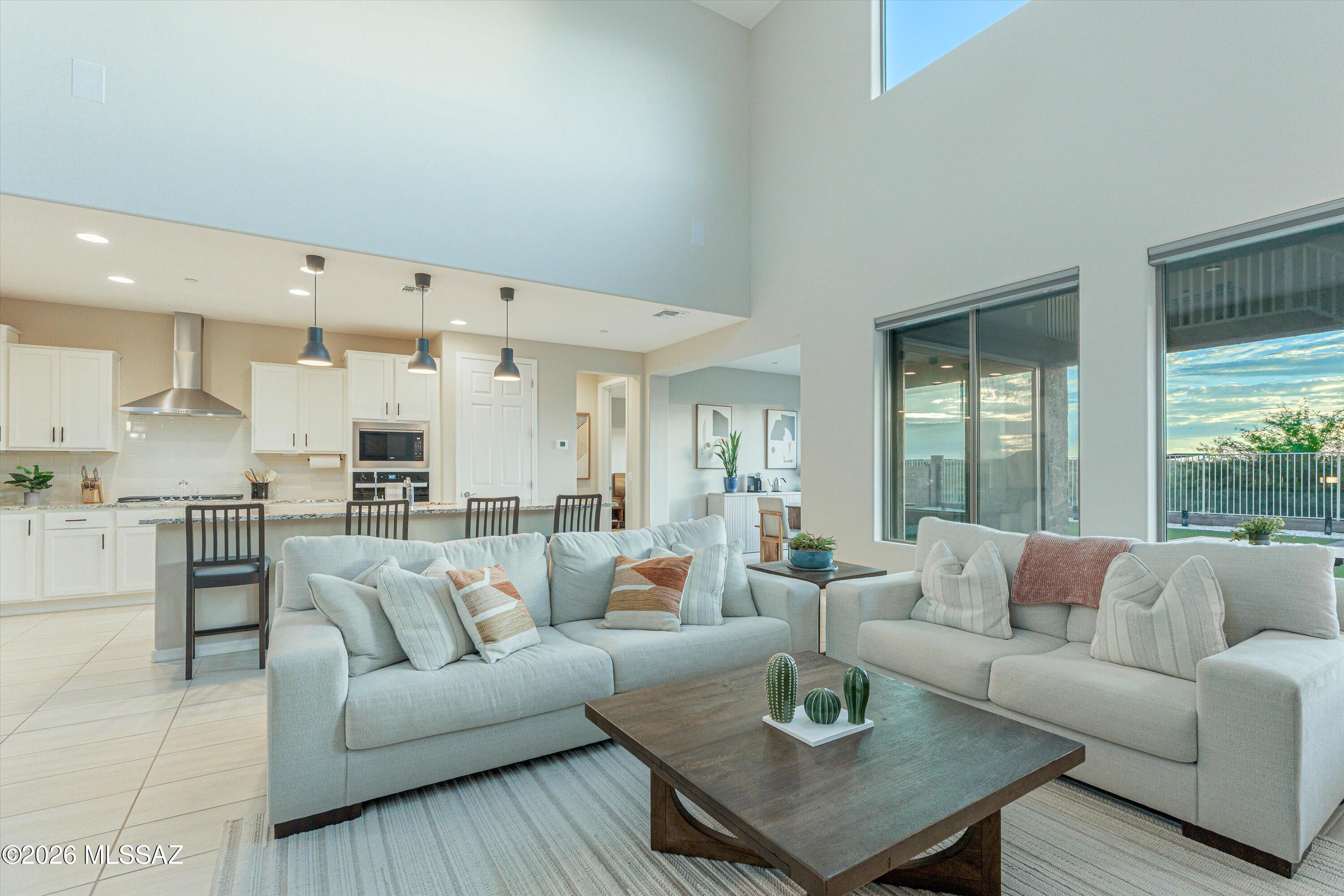 Welcome to modern luxury with this pristine 2024-built home! Thoughtfully designed with 5 bedrooms, 4.5 baths, and a versatile den, this spacious residence offers exceptional flexibility for family, guests, or multigenerational living.

At the heart of the home, the chef's kitchen shines with a gas cooktop, rich granite countertops, an expansive island, and a walk-in pantry. Step outside to your professionally landscaped backyard paradise to savor unobstructed views of the majestic Santa Rita Mountains, or admire stunning Rincon Mountain vistas from the front porch.

Meticulously maintained and professionally cleaned every two weeks, this move-in-ready home offers the best of new construction without the wait!