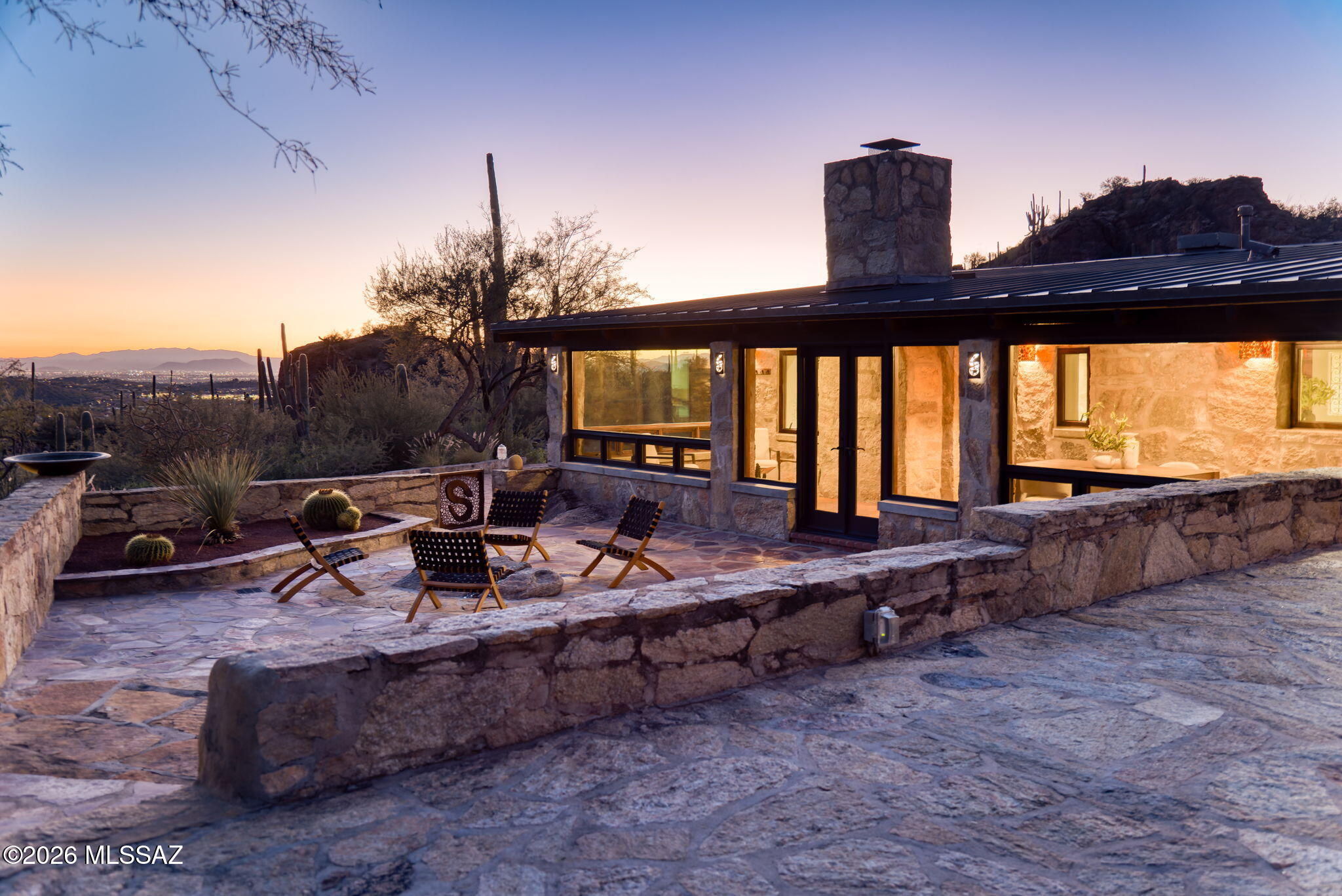 A rare offering in exclusive, gated Rattlesnake Canyon Estates, this extraordinary 36.2-acre creekside property is adjacent to Sabino Canyon & borders the Coronado National Forest, delivering unparalleled privacy, scale, & proximity in a coveted foothills setting.  This is a singular opportunity w/ nothing comparable in Tucson. Built in 1956, this is the only lot in Rattlesnake Canyon w/ a well & city water.  Known as the ''Rock House,'' the iconic residence reflects exceptional architectural authenticity, constructed using chipped stone sourced directly from the land. The property includes a 2,290-square-foot main residence, oversized two-car garage, and a 765-square-foot guest casita, all approached by a private gated entry & and long paver-lined driveway. CONT... A charming pond, & terraced stone patios, create multiple outdoor living environments with unparalleled views in every direction. Custom metalwork is featured throughout, complemented by hand-hewn beams, carved interior doors, stacked-stone fireplace, Marvin windows, and artisan details. Renovations include the addition of the  primary bath with stone shower in 2007, with the garage and guest casita added in 2012. This is the only property in Rattlesnake Canyon Estates with a private well. Direct access to endless hiking and biking trails completes this truly irreplaceable offering.

Sited high within the canyon, the property commands close-up Catalina Mountain views, sweeping valley & city lights, layered canyon silhouettes, & dramatic sunrises & sunsets. The east patio is thoughtfully sited to capture 360-degree views & seamless indoor-outdoor living. 
Situated behind two gated entries between the Sabino and Ventana Canyon corridors, the setting offers remarkable seclusion without isolationjust minutes to world-famous Canyon Ranch Wellness Resort & Spa, premier dining, shopping, & world-class golf.

A seasonal desert creek enhances the land, offering the rare experience of water in the Sonoran Desert. 
One of only five parcels in this gated enclaveranging from 36-49 acres. Historic grinding stones found throughout the property.