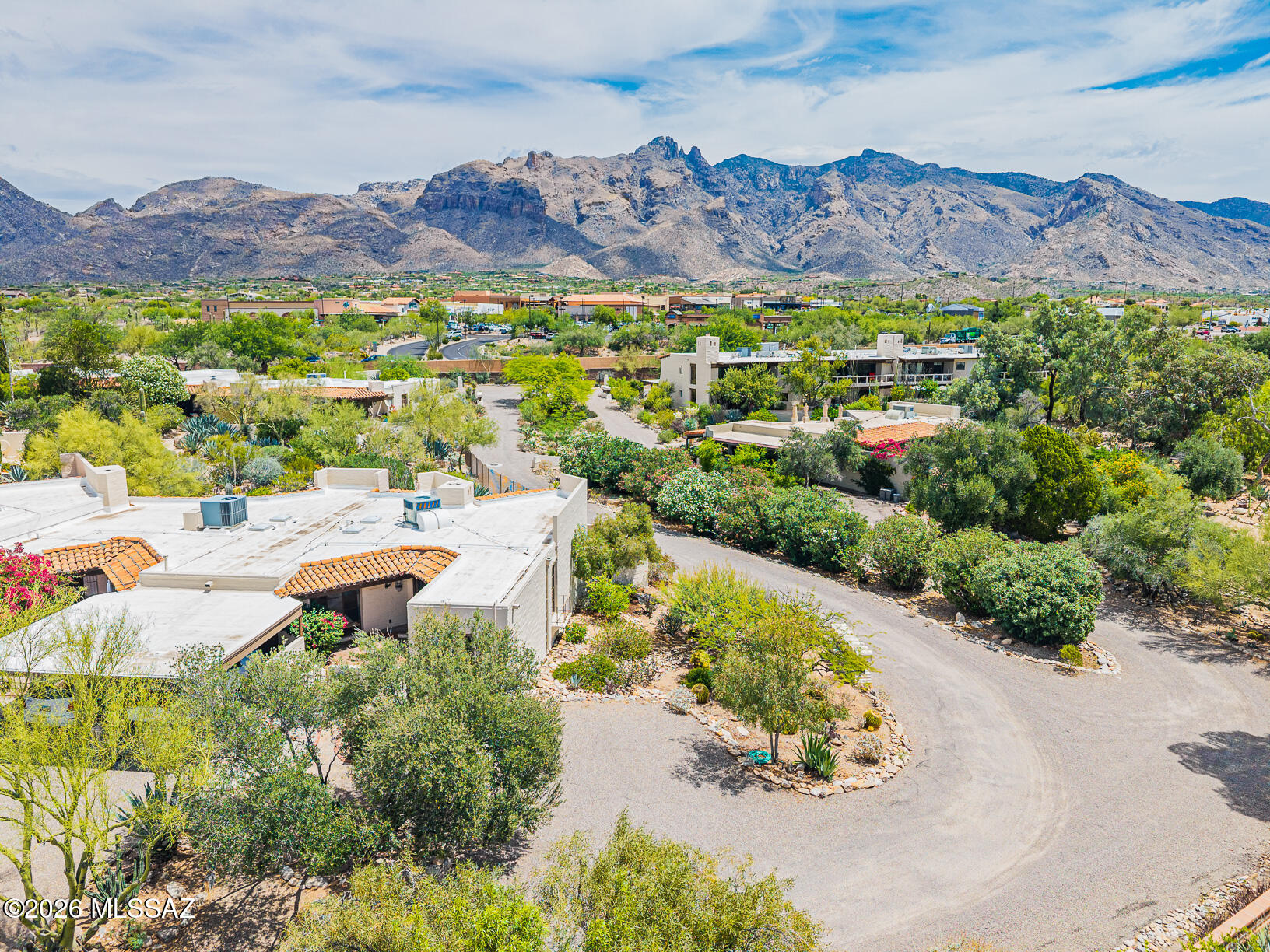 This architecturally significant townhome community, designed by renowned architect Juan Worner Baz, in conjunction w/Japanese landscape architect Taro Akutagawa, is listed in the Natl Register of Historic Places. Enjoy expanded patio w/panoramic Catalina Mountain views to Finger Rock. Mature desert landscaping incl/saguaros, cypress, eucalyptus trees, agave & aloe plants, & an impeccable flowering desert garden. Enjoy walking paths adorned w/statues, unique community pool, waterfalls, & Koi Pond. Addtl highlights of this special 2BR, 2BA home incl/a private carport w/one addtl covered space, multiple storage closets, & addtl adjacent guest parking. HOA dues cover ALOT (water, sewer, trash, fire subscription, exterior painting, roof maintenance, landscaping, & common area upkeep.