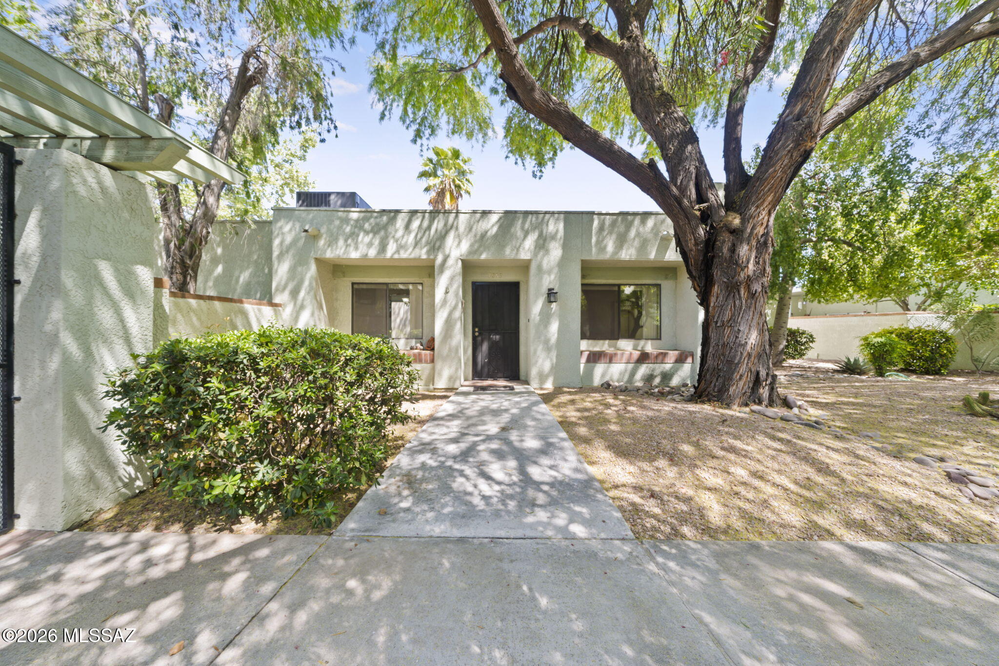Highly desirable townhome with 2 Bedrooms and a 2-car garage! Sunlight pours through skylights into the inviting living room, where a cozy fireplace and stylish wet bar create the perfect space to unwind or entertain. The kitchen shines with stainless steel appliances, wood cabinetry, granite counters, pantry, and a serving window with a breakfast bar. The primary suite offers an abundance of space, a private bath, and a walk-in closet. Enjoy your covered patio and attached garage cabinets for extra storage. Located in a gated community with a sparkling pool and great local amenities. This one is ready for you.