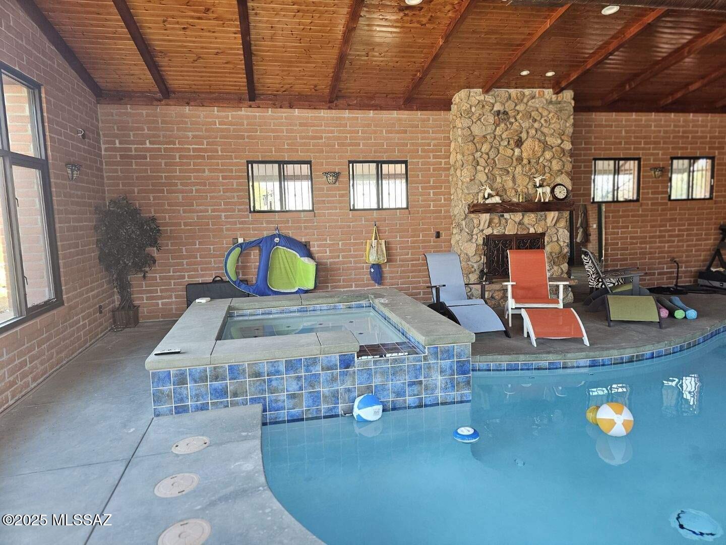 Relax here in this unique furnished guest house situated in a great northwest location here in Tucson that offers so many amenities! You will enjoy the comfortable movie theater seating in the living room and dining area the looks out at the community property indoor pool and heated spa or relax outside in the backyard. There is a dining area outside as well with mountain view. The modern kitchen is fully stocked with small appliances and housewares and features a gas range. Stackable washer & dryer is also available for your use. Bedroom has a queen bed and you have access to the rooftop deck for sunbathing or to enjoy the sunset and sunrises here in the beautiful desert. RV parking space is available and close proximity to hiking, biking, shopping & so much more.