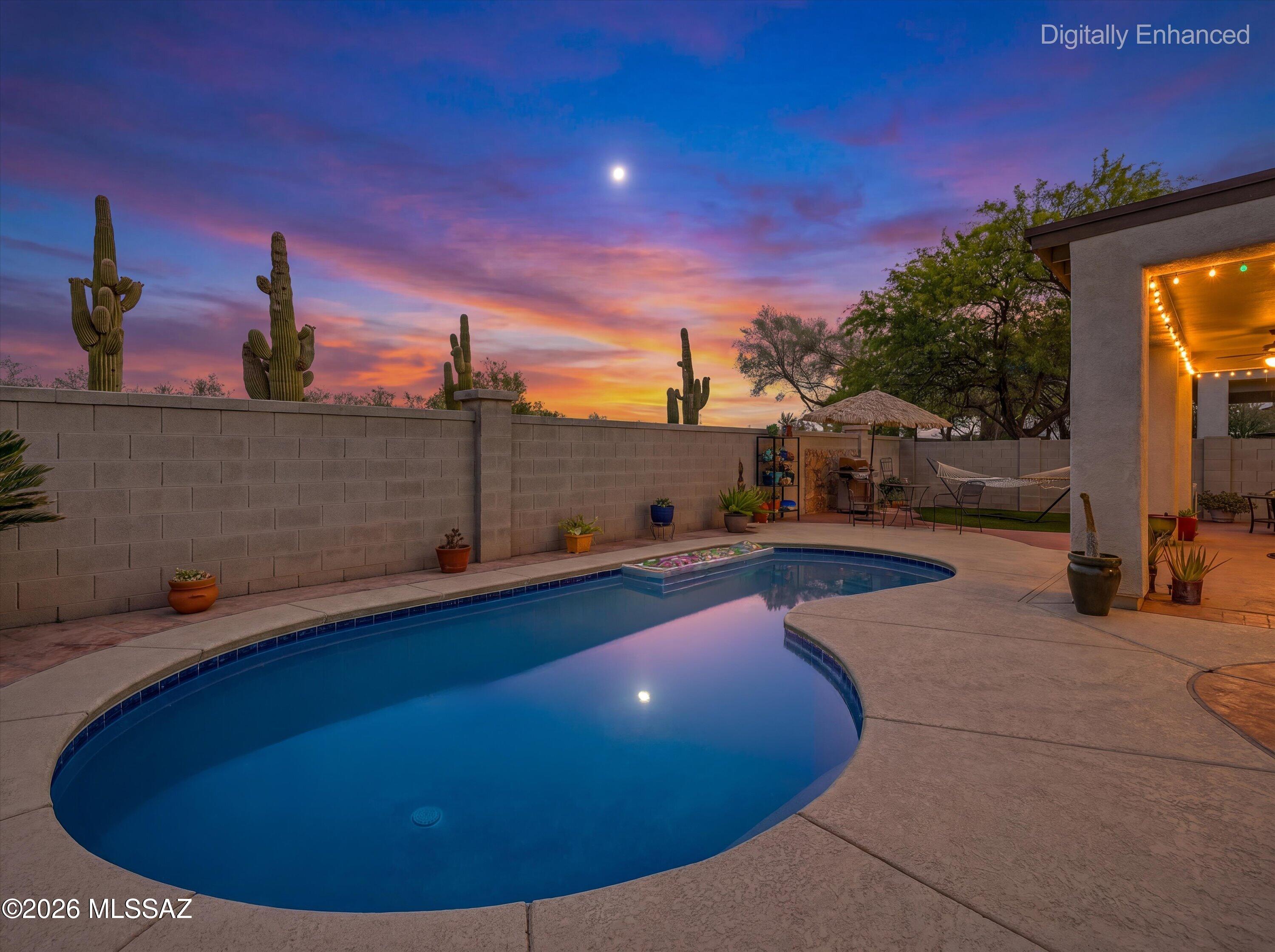 Welcome to this beautifully maintained single-story home nestled in one of Rancho Sahuarita's most desirable locations, just moments from Sahuarita Lake, the clubhouse, fitness center, parks, walking trails, and the community's incredible amenities. From the moment you arrive, you'll be captivated by the home's immaculate curb appeal. An extra-long driveway leads to a spacious three-car garage framed by stunning saguaro cacti and meticulously manicured landscaping, creating a truly memorable first impression. The charming front courtyard provides the perfect place to relax and enjoy Arizona's beautiful weather while adding to the home's welcoming character. Inside, pride of ownership is evident throughout. Fresh interior paint, updated lighting, and a light, bright, and airy floorplan create an inviting atmosphere that feels instantly like home. The spacious living and dining areas are anchored by a beautiful gas fireplace, creating a warm focal point for everyday living and entertaining. The thoughtfully designed kitchen features an updated backsplash, abundant cabinetry, generous counter space, and a functional layout that makes both cooking and gathering a pleasure. Two of the three bedrooms feature durable Pergo XP flooring, adding both style and practicality, while the home's newer water heater provides additional peace of mind.
The backyard is where this home truly shines. Backing directly to Rancho Sahuarita's scenic saguaro-lined wilderness trail with no rear neighbors, you'll enjoy exceptional privacy and breathtaking desert surroundings. The sparkling pool has been newly replastered and is ready for endless summer enjoyment. Beautifully maintained landscaping and inviting outdoor living spaces create the perfect setting for entertaining, relaxing, or simply enjoying the tranquility of your own private oasis.
Move-in ready and exceptionally cared for, this home also features a newer roof, making it as practical as it is beautiful. Combining outstanding curb appeal, a highly sought-after location near the heart of Rancho Sahuarita, a private backyard retreat, and numerous thoughtful updates throughout, this property offers incredible value and a lifestyle that is difficult to match. This is Arizona living at its finest