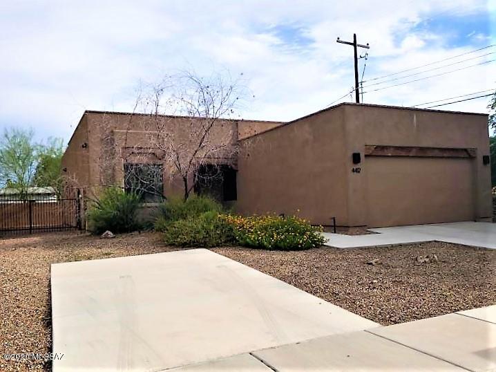 Centrally located modern GEM waiting for you!! Featuring scored concrete floors, soaring ceilings, recessed lighting, and a WIDE OPEN Great Room plan. Kitchen features dark wood cabinets, with solid surface counter tops, spacious island/breakfast bar and stainless steel appliances. Owners suite features dual vanities and a tile walk in shower, Hall bath features a tub/shower combo. Ceiling fans included in living and bedrooms as well as the back patio! 2 car garage with extra concrete pad in front for parking.  PETS: small animal with owner approval. Tenant occupied until 06/30/26