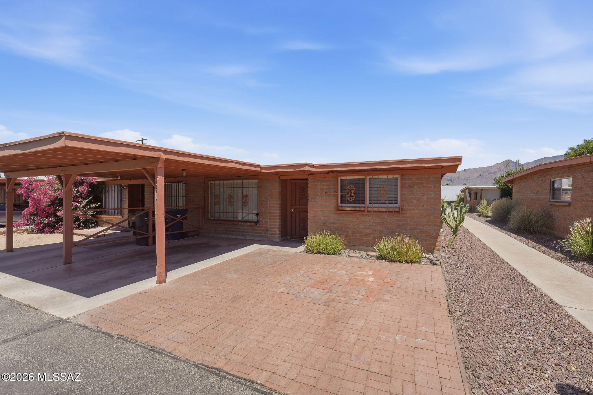 Charming 3-bedroom, 2-bath, 1,121 sq ft townhome in central Tucson. Features a great room, dining area, spacious bedrooms, tile flooring, ceiling fans throughout, and in-unit washer/dryer. Enjoy a private, low-care patio, security doors/bars, and single covered carport. Community offers a playground and pool. A very well-located home near shopping, dining, and transportation.
