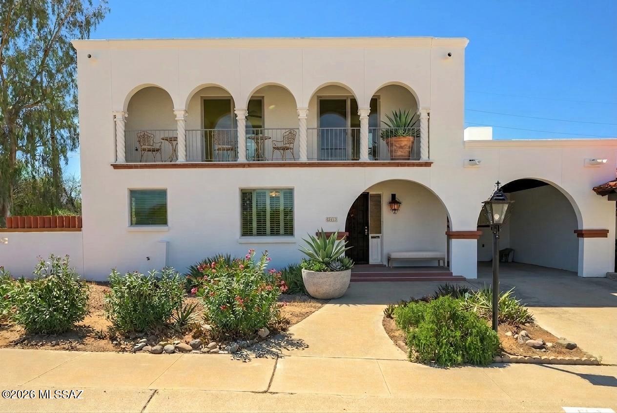 Welcome to a truly special opportunity to enjoy timeless Spanish architecture and modern updates in the heart of Green Valley. This classic two-story townhouse is one of the original homes built in the area, situated on an expansive .28-acre corner lot that offers exceptional privacy and stunning mountain views from the upstairs balcony.  Perfectly tailored for active retirees, this residence boasts an ideal blend of low-maintenance features and inviting communal spaces. The main level showcases travertine tile and durable oak tongue-and-groove flooring, ensuring effortless upkeep so you can spend more time enjoying the vibrant community. The thoughtfully updated kitchen shines with quartz countertops, a decorative range hood, a pantry closet, and an open-concept dining area, perfect for casual meals or entertaining friends.  The living room centers around a cozy gas fireplace, framed by built-in bookcases for your favorite reads or display pieces. The primary suite is conveniently located on the main floor, while the versatile upstairs area is ideal for visiting guests, office space, or multi-generational living. A separate laundry and workshop combo, complete with a functional sink and additional toilet, offers ample room for hobbies, crafts, or even a personal studio. Step outside to a generous covered patio, the perfect spot to enjoy Arizona's beautiful weather.
Low HOA dues and a central location put you close to shopping, dining, and Green Valley's renowned recreation amenities. Discover comfort, character, and community in this unique townhome designed for your best years yet!