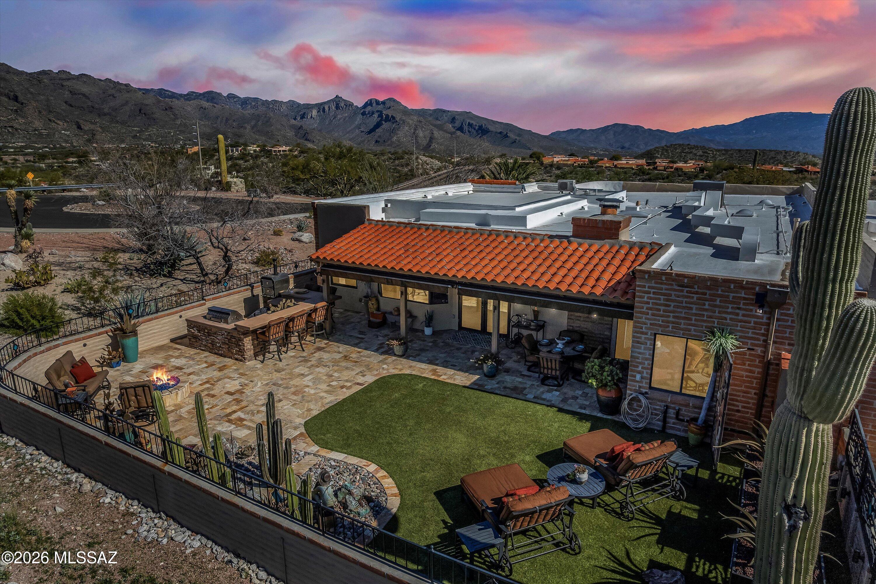 Experience elevated desert living in this impeccably appointed townhome with sweeping city and mountain views. Offering 3 bedrooms, den, bonus/flex room off the primary & 3 baths across just over 2500 sq ft, this home blends elegance with versatility. The great room with fireplace is complemented by a chef-inspired kitchen featuring GE SS appliances & an oversized island, along with a separate dining area ideal for entertaining. Retractable shades provide comfort throughout. Exterior living includes artificial turf, an outdoor kitchen w/pizza oven, and firepit perfect for gatherings. Exceptional design, space and views! Some furniture offered on a separate bill of sale. Seller has installed a brand new HVAC system and it has a 10 year warranty.