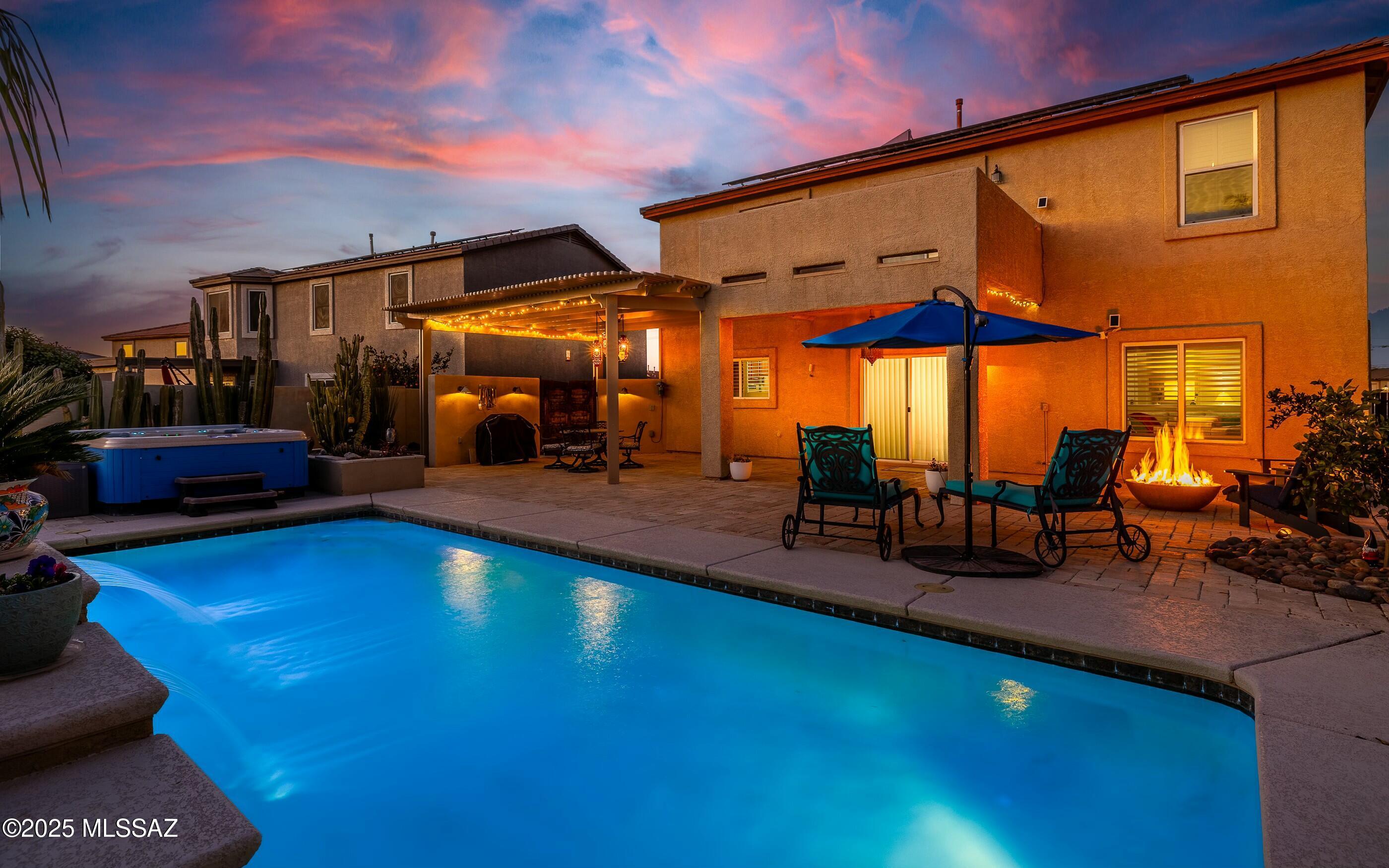 This exceptional home offers OWNED solar for low year-round utilities! The backyard oasis is an entertainer's dream, featuring a custom pool with a waterfall, travertine pavers, a gas fire pit, and stunning custom lighting. A 19th-centurey Italian garden gate adds old-world charm, while a rainwater cistern, fruit trees, and a raised garden bed enhance functionality. Inside, enjoy new luxury vinyl flooring, fresh modern paint, upgraded lighting, and a serene primary suite with a balcony, mountain views, and a spa-like ensuite. The chef's kitchen boasts stainless appliances, a gas range, granite counters, and classic cabinets. Highlights include a bright, open living area, a three-car garage, and an extended patio for resort-style living. This home combines luxury and practicality!