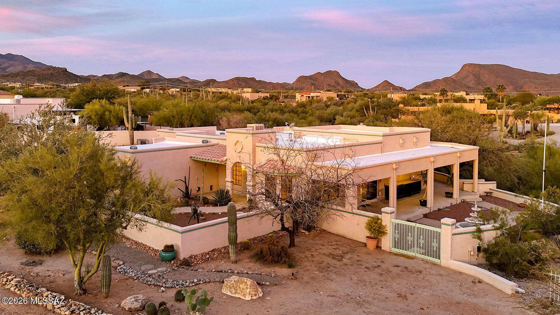 Immaculate 3-bedroom, 2.5-bath home on a beautifully landscaped 1+ acre west-side lot with sweeping city & Catalina Mt/Tucson MT views. Terraced landscaping, walkways, & a charming matching casita/shed enhance the setting. The open kitchen is open to the family room and features custom cabinetry, newer granite, instant hot water/filtration, and abundant natural light. Tiled floors throughout. The primary suite includes an updated bath w/ travertine shower, executive-height vanity, granite counters, custom built-ins, and a large walk-in closet. Outdoor living is exceptional w/ a northwest-facing patio off the dining rm, a ramada w/FP fountain. Rare 5-car garage (2-car plus heated/cooled 3-car garage) with half bath, microwave,  & work areas. Beautiful!