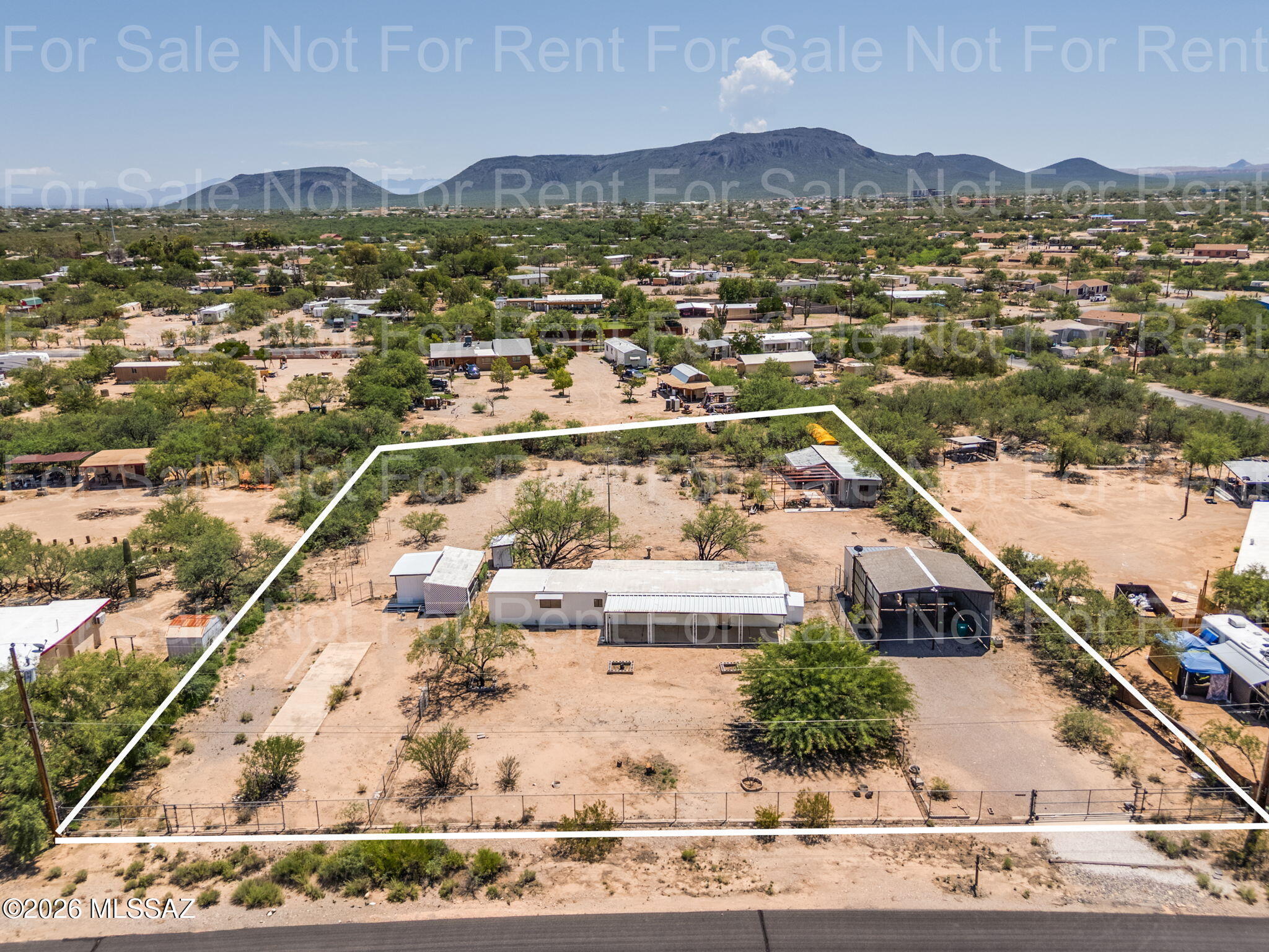 NEARLY 1 ACRE | 2BR/1BA | ROOM FOR 2ND MANUFACTURED HOME
Opportunity, space and flexibility on Tucson's southwest side! Situated on approximately .9988 acres (43,507 sq. ft.), this property features an existing 1974, 2-bedroom, 1-bath non-affixed manufactured home with plenty of room to spread out and explore future possibilities.
Located in non-flood zone, the property features SH zoning with room and hookups for a potential second manufactured home, creating possibilities for multi-generational living, an additional residence or investment use. Buyer to independently verify zoning, permitting, utilities, septic and all requirements for placement of an additional manufactured home.  HORSE ZONED more_> Existing improvements include refrigeration cooling, an enclosed porch, septic and a large covered carport providing generous parking and additional usable space.Enjoy the space and flexibility of nearly a full acre while remaining conveniently located to I-19 and Tucson Spectrum, offering nearby shopping, dining and entertainment including Home Depot, Harkins Tucson Spectrum 18, restaurants and everyday services. A great combination of room to spread out without giving up convenient access to Tucson amenities.
Property is being sold AS-IS in its current condition. Deserted vehicle and all personal property remaining on the premises at closing will convey with the sale.
Bring your tools, ideas and vision! Whether renovating the existing home, creating additional outdoor space or exploring the potential for a second manufactured home, this property offers an increasingly hard-to-find combination of land, flexibility and opportunity in Southwest Tucson.