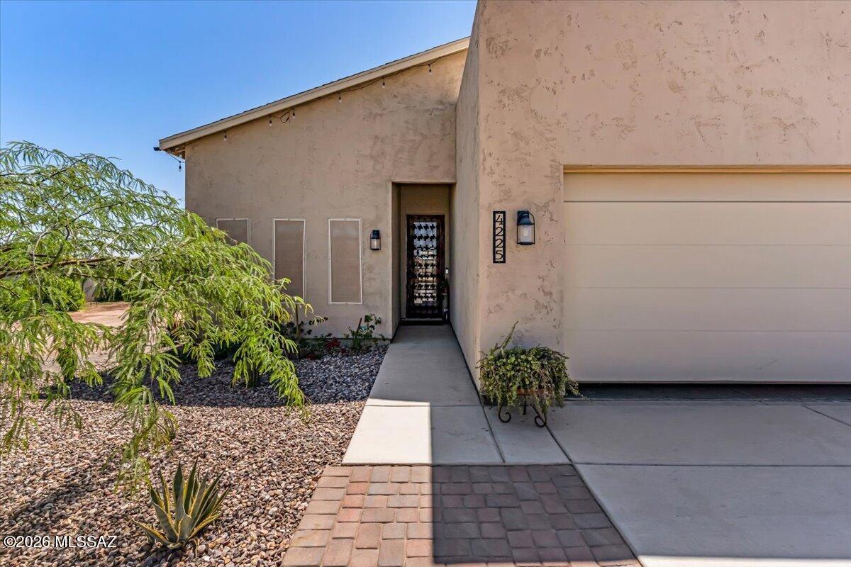 Rare opportunity in Eloy to own your very own private compound on a fully fenced .35-acre lot with block wall perimeter, electric iron gate access with no HOA. This property offers space, privacy, functionality and beautiful upgrades throughout. Step inside to find two primary bedrooms, three full bathrooms, vaulted ceilings, laminate flooring throughout and a spacious open layout designed for comfortable everyday living. The large kitchen features a generous island, quartz countertops, stainless steel appliances, a pot filler and plenty of room to gather. Custom tile work adds style and character throughout the home. Outdoors, enjoy easy-care landscaping with pavers, decorative gravel, shrubbery and room to make the space your own. A standout feature is the 600 sq. ft. detached permitted workshop with garage door access, perfect for hobbies, storage, projects, tools, toys, or additional workspace. This unique property offers a rare combination of residential comfort, usable outdoor space, and workshop functionality all behind a private gated entrance.