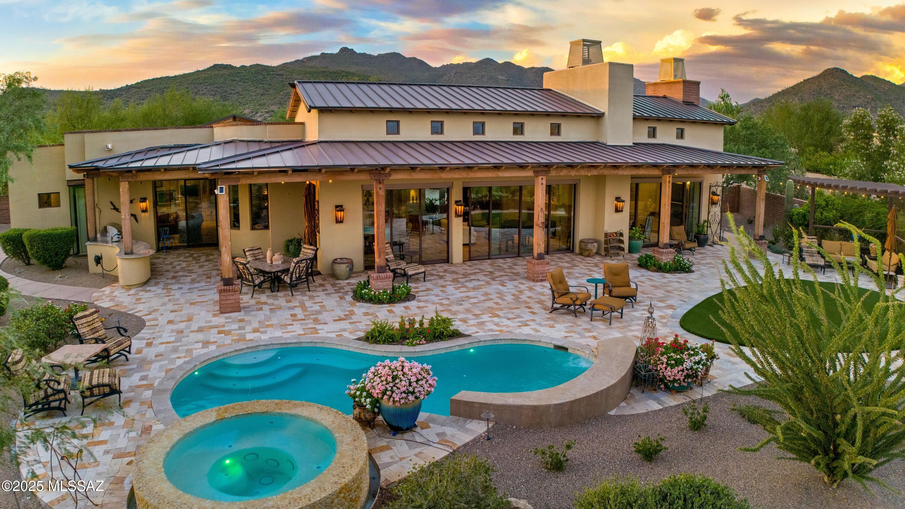 Welcome to The Ritz-Carlton Residences, Dove Mountain. Perched on the most coveted homesite in the community, this exquisite estate combines a timeless main residence with a private guest house, designed to capture sweeping views of the surrounding mountains, golf course, city lights, and both sunrise & sunset. 

The Main House offers all ensuite bedrooms, a versatile den, soaring ceilings, a chef's kitchen, and a custom bar space. Designer, luxury finishes throughout create a seamless blend of elegance and modern convenience.

The outdoor spaces rival the beauty of a five-star resort. Lush, meticulously designed gardens and vibrant desert landscaping surround a sparkling pool, spa, and outdoor kitchen - offering an inviting backdrop to both quiet retreats and lively gatherings. As part of The Ritz-Carlton Residences, homeowners enjoy access to resort amenities, concierge services, social events, and more. Owners enjoy membership at The Golf Club at Dove Mountain.
 
View Property Website Here: https://listings.kccreativedesign.com/6167-W-Seven-Saguaros-Cir-Marana-AZ-85658-USA
