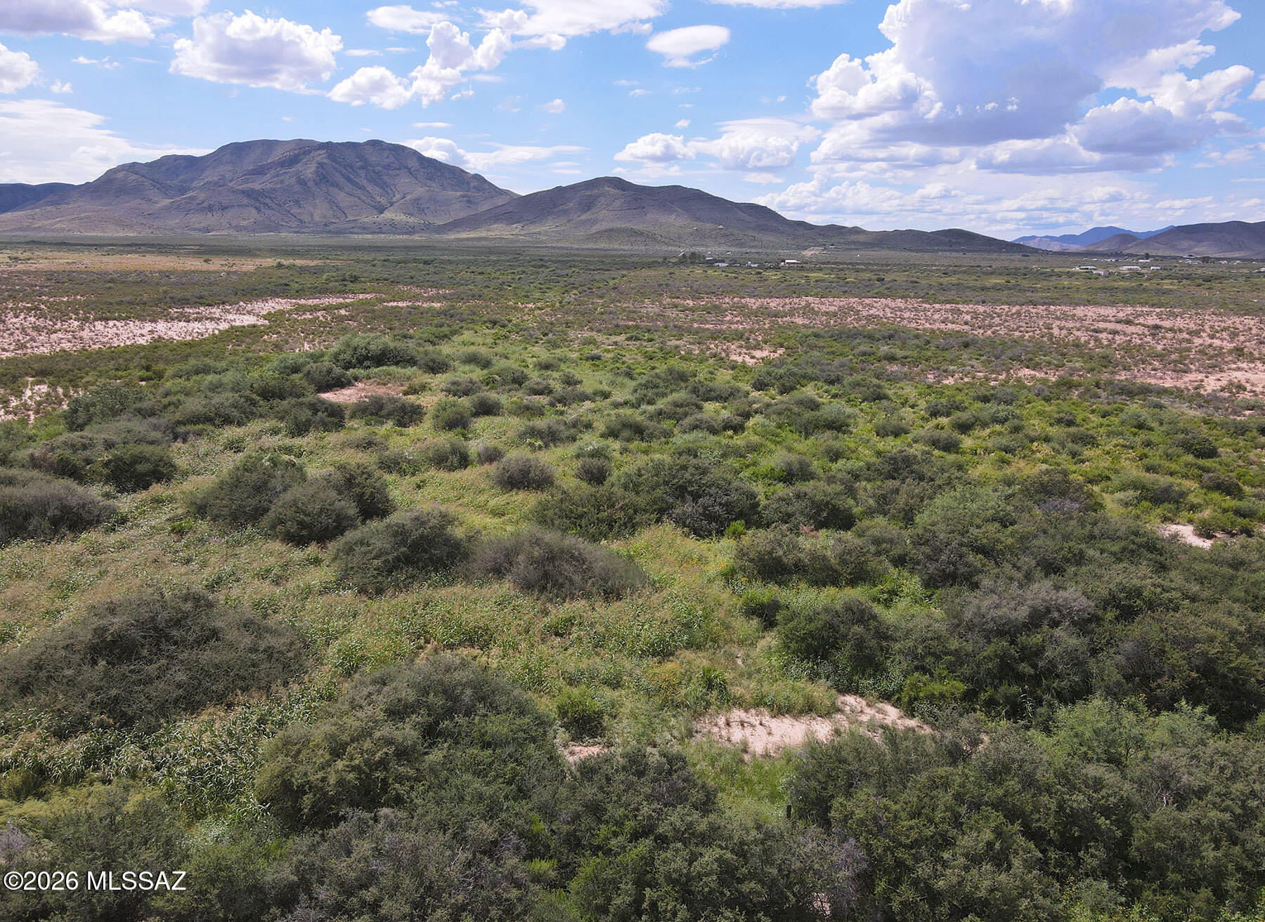 Completely secluded 11 acres with easy access from paved Dragoon Rd. and panoramic views of the Dragoons & surrounding mountains. Bordering hundreds of acres of private ranch land, views & personal space will be protected far into the future. A small seasonal dry creek runs the southern edge of the property with thick vegetation, some large trees, flowers, grasses and tons of wildlife. The property is partially fenced and zoned RU-4, allowing site-built, manufactured, & modular homes while qualifying for the Cochise County owner-builder opt-out exemption. Drill well or haul water. Power is approximately 1/4 mile away. Tucked away just off paved Dragoon Road, it's less than 15 minutes to I-10 for easy trips to Benson or Willcox. Act now to secure this special spot!