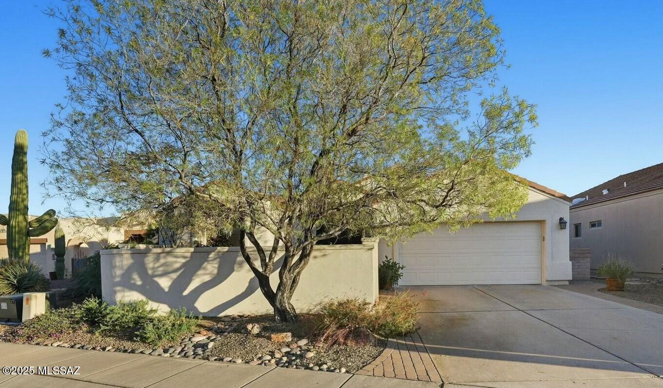 This beautiful home is located in the gated Greens at Santa Rita Springs. Ideally situated near golf courses, shopping, recreation centers, and grocery stores. Impeccably maintained, it boasts numerous updates and improvements, including fresh interior paint, new irrigation, professional landscaping, and a pergola with a fan and lights, among other thoughtful touches. The front courtyard provides a serene retreat with a fountain and privacy wall, perfect for relaxing or entertaining. Inside, the home feels warm and inviting, featuring vaulted ceilings, a double-sided gas fireplace serving both the formal and informal living areas, and large windows that fill the space with natural light. The chef's kitchen is a dream, with painted soft-close cabinets, new granite countertops, a custom island, a stainless-steel farm sink, and a Samsung induction/convection range and oven. Elegant new Silhouette window coverings and draperies complement the gorgeous tile floors throughout the home. The bathrooms have been updated with new glass shower doors and partitions, cultured marble countertops, and heavy-duty toilets, creating a spa-like experience. A screened-in back porch, expansive pavered areas, and mature landscaping provide the perfect setting to create your own private backyard oasis. This is truly a once-in-a-lifetime opportunity to enjoy comfort, style, and the active Arizona lifestyle.
