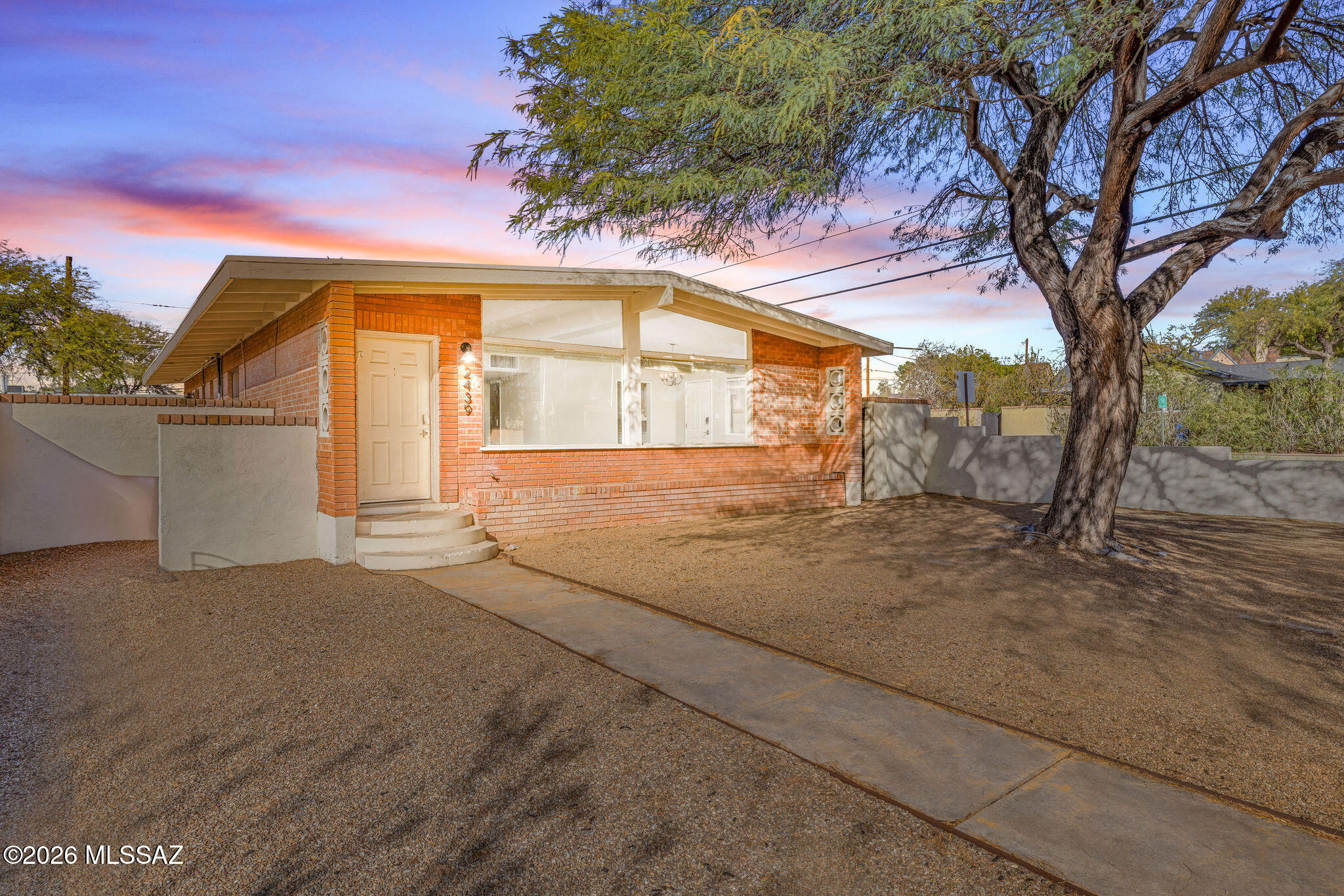 Amazing opportunity for updated 1,623 SqFt 4 bed/2 full bath Mid-Century Modern red brick ranch home on premium .16 acre R1 corner lot, located in vaunted Sam Hughes elementary school district in historic Sam Hughes community within thriving Central Tucson.  Unique opportunity to own a historic eligible home (possible reduced property taxes w/primary residence) built in 1959 that retains its vintage character and charm with updated modern amenities.
Featuring no HOA, N/S orientation, mountain views, single story, low maintenance xeriscaping front yard, on & off-street parking (no permits required), gated front yard w/concrete sidewalk leads to built-in raised brick flower gardens and energy efficient front door. Inside buyers will appreciate tall vaulted painted ceilings, luxury plank flooring with plush carpet in bedrooms, new gas roof HVAC 2021, Honeywell Pro Series Smart digital thermostat, built in alarm, digital Ring camera, internal laundry w/washer & dryer included, spacious great room with expansive South facing windows providing stunning natural light, wood burning with gas option brick fireplace, formal dining area, updated kitchen with stainless steel appliance package including updated oven, dishwasher, refrigerator, metal dual sink with garbage disposal and LG built-in microwave. Sizeable guest bedrooms, full size guest bathroom with executive height tiled modern vanity, and large primary bedroom with private ensuite full bathroom with walk-in shower. Enjoy tranquil Tucson nights in private low maintenance backyard with alley access garage and storage shed, updated 200 AMP electrical service surrounded by tall masonry stucco privacy walls.
Spectacular Central Tucson location featuring great walkability score of 81, and a biker's paradise 98 bike score! Located just one block from restaurants and shopping including Sonoran Coffee house, Redbird Scratch Kitchen + Bar, Bob Dobbs, Borderlands and Tumerico, which was recently named the #1 place to eat in America by Yelp!
Minutes away from Himmel Park, 24.3 acre urban park with 8 lighted public tennis courts, refreshing public pool, two playgrounds, a grass amphitheater and 4 full sized grass soccer fields, public library, vaunted Sam Hughes elementary school,  Banner Medical and the University of Arizona, Randolph public golf courses & tennis court, Reid Park Zoo, U of A Baseball at Hi Corbett Field, El Con Mall with groceries, shopping, and full size movie theater. 
Great solution for those looking for a rental property (rented for $2250 a month), Air B-n-B property, seasonal visitors, homeowners shopping in Sam Hughes, parents looking to secure student housing, U of A, Banner Medical professionals and investors alike! I promise, this beautiful property won't last long, call to make your appointment to view this Sam Hughes classic today!!!