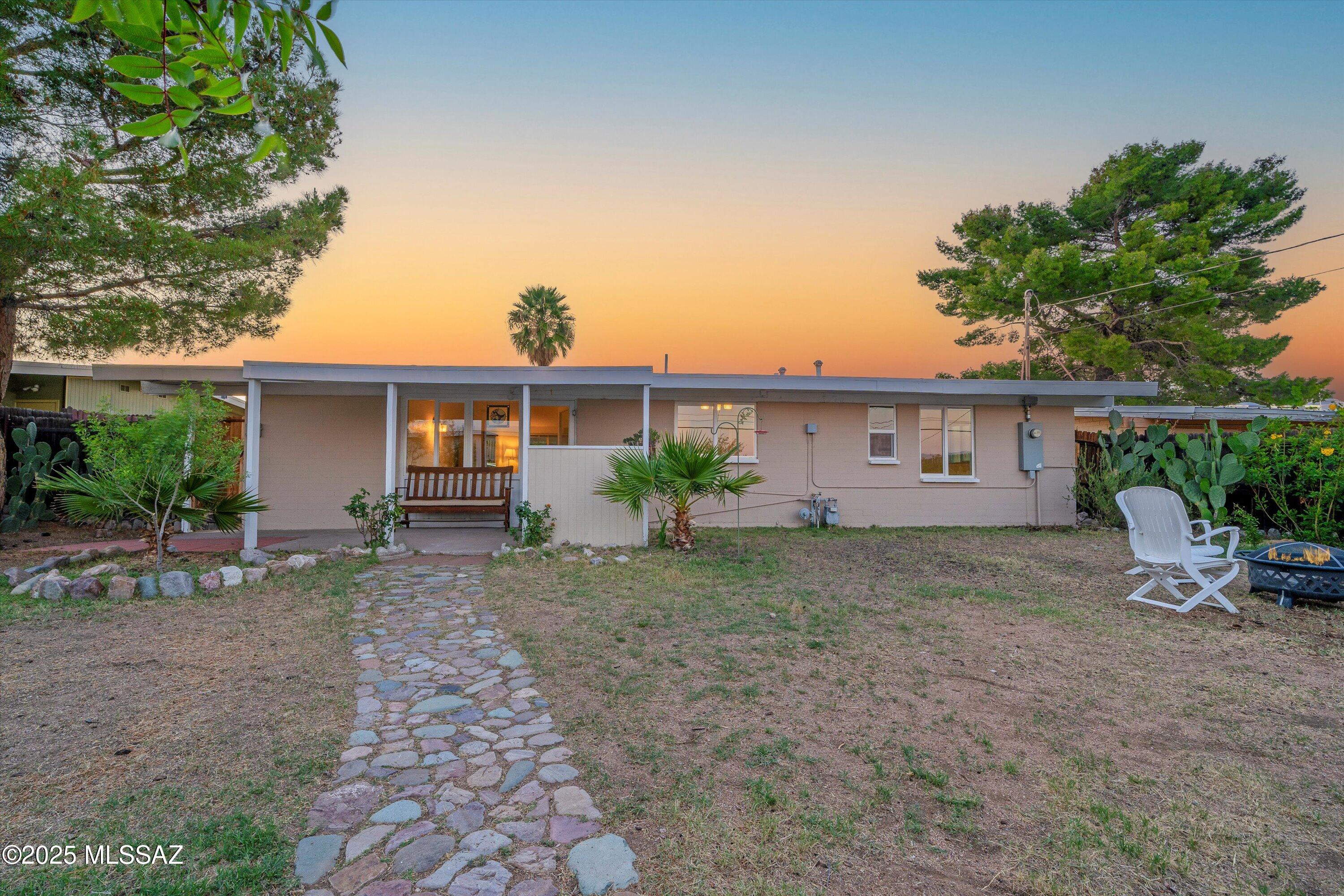 Well-maintained home with beautiful landscaping in both the front and back yards, featuring custom wood countertops and unique artistic touches throughout. The remodeled kitchen includes all appliances. Interior upgrades include tile and wood laminate flooring, dual pane windows, and central AC for comfort and efficiency. The over-height, expanded 2-car garage with alley access is a craftsman's dream, offering incredible mountain views and excellent workspace potential. Backyard is completely fenced and features a covered back porch--perfect for relaxing or entertaining. Conveniently located close to the natural desert and abundant outdoor recreation opportunities.