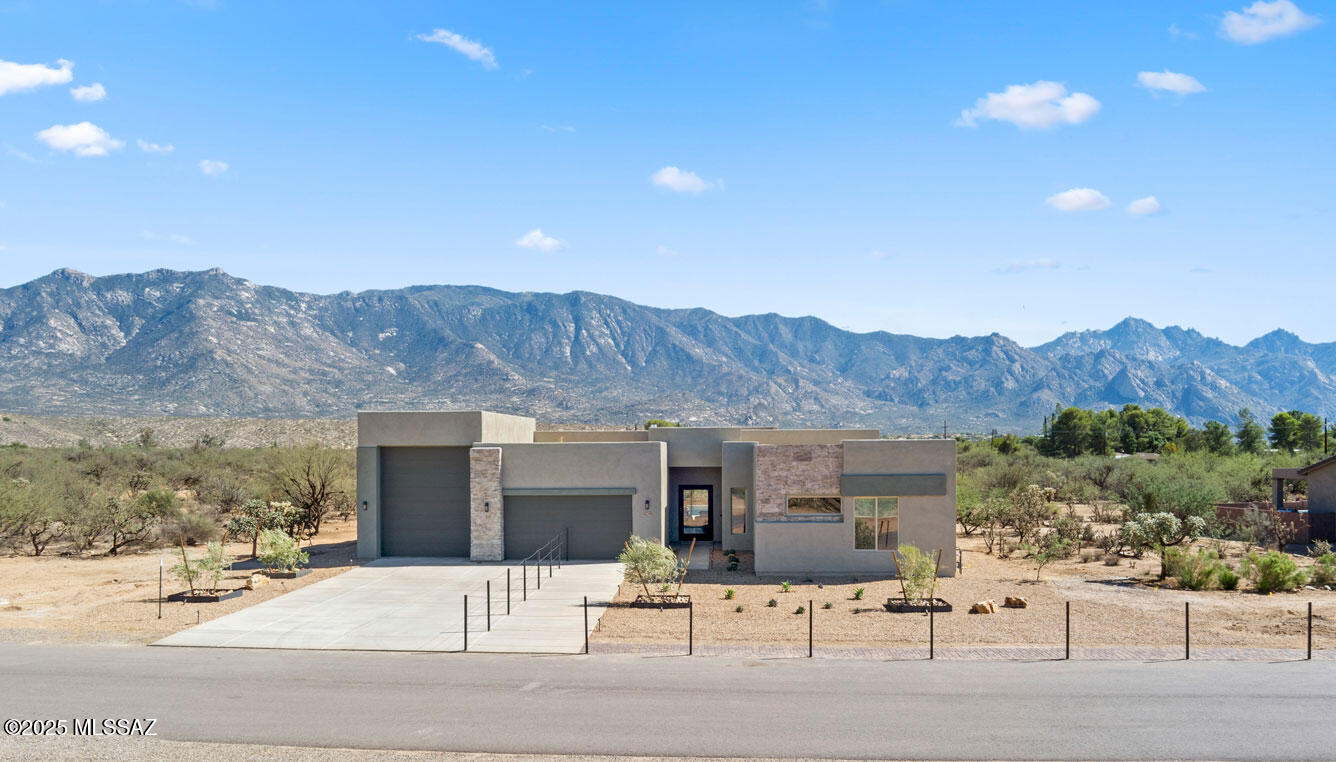 Spacious Acacia plan featuring 3 en suite bedrooms, a big flex space, an office, 12′ ceilings, and a 16'X10′ multi-slide to a private covered patio. RV GARAGE!! This home features a modern exterior with stone accents with an amazing Catalina Mountain Views! Beautiful back and front yard landscaping with a pool! Home is under construction.  *AVAILABLE AS MODEL LEASEBACK* Call for details. Renderings are conceptual and may not depict the exact final product.