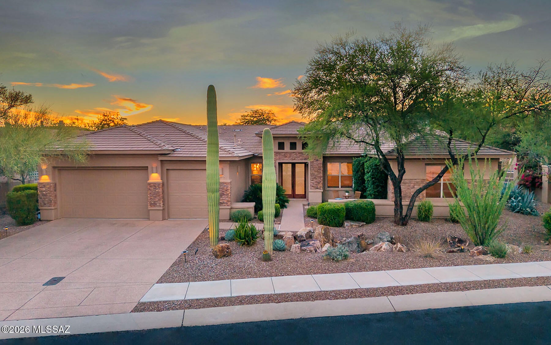 This stunning Pepper Viner-built former model is located in a prestigious, gated enclave of Rancho Vistoso and epitomizes Oro Valley luxury living. Offering a de- sirable split 4bd.,3ba., floor plan plus den         or playroom, this home is rich with custom upgrades and exquisite detail throughout. The gourmet kitchen is a chef's dream, featuring granite slab countertops, custom cabinetry, and premium stainless-steel appliances including a Sub-Zero refrigerator ,and Wolf cooktop. The kitchen opens to the cozy family room, highlighted by a custom stone fireplace with a mesquite mantel from the Tumacácori Mesquite  Sawmill. Warm neutral ceramic tile flows throughout the main living areas, with plush carpet  in the bedrooms.  Additional interior highlights include plantation shutters... designer paint, custom built-ins with accent lighting, 8' interior doors, a built-in sound system, and expanded storage in the guest suite.
Step outside to a true resort-style backyard designed for year-round enjoyment. Features include an expansive covered patio with motorized sunshades, flagstone hardscape, a built-in BBQ and grill island, a fire pit, lush landscaping, fruit trees, and a sparkling, self-cleaning PebbleTec pool and spa.
Completing the property is an oversized 3-car garage featuring epoxy floors and built-in storage cabinets. This exceptional residence offers breathtaking mountain views, privacy, and refined desert living in one of Rancho Vistoso's most sought-after gated communities. Move-in ready--this home is special and will not disappoint. Welcome home!