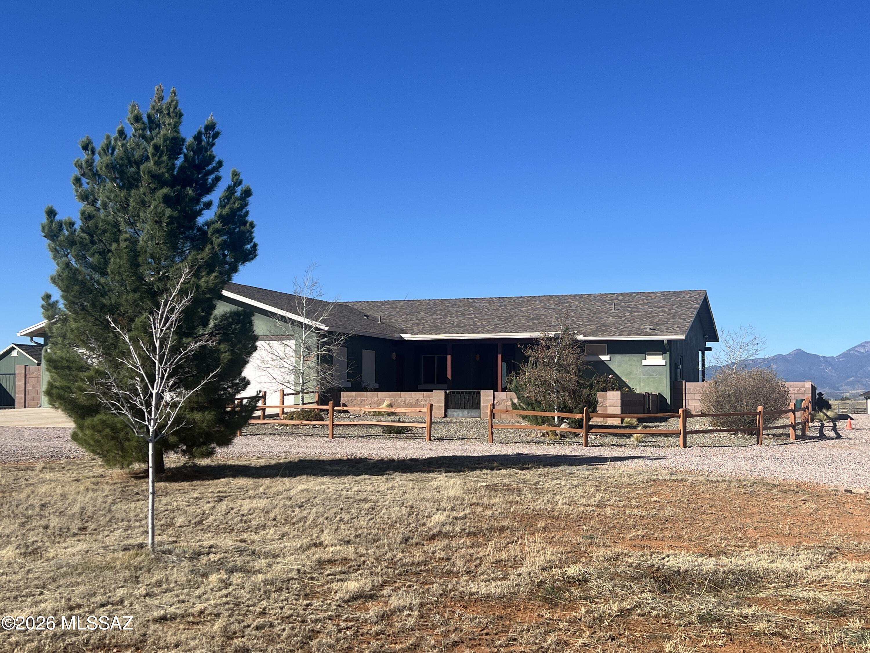 Turn Key Horse Property!! This meticulously maintained 2339sqft 2 bedroom, 21/2 bath 2014 custom home on 9.72 acres features: Open floor plan with spacious kitchen, stainless steel appliances, granite countertops with plenty of space for baking/entertaining, alder cabinets, walk in pantry, breakfast bar, dining area with views of the Santa Rita mountains, cozy great room with pellet stove, office/den/craft room, split floor plan, provides 2 spacious master bedrooms with exterior entrances that are ensuite, walk-in closets, custom tile showers, main master has a 2  head shower and a double sink vanity, large laundry room, guest bathroom, oversized 3 car garage (truck deep), water softener, reverse osmosis system under kitchen sink, central vac, utility sink in garage. Let's go outside! Beautiful low care landscaped back and front yard, covered porches, waterfall feature, shed in yard, irrigation system, pavers, flowers, trees, block wall, decorative rock and gravel. Horse facilities include 3-stall MD metal barn with runs, separate tack and feed rooms, pavers, wash rack, perimeter fenced with cross fenced pastures for turn out and rotational grazing, riding arena with lights built with base layer and washed sand for the ultimate footing! Did I mention it has lights! 800 sqft shop building with walk through and roll up doors, 15' X 40' RV garage with 14' roll-up door, well house encloses the private well, pressure tank, filter system, back-up generator and additional work/storage space. Beautifully landscaped with flowering plants and fruit trees all on low care irrigation system. Surrounded by 360 degree views of mountain ranges, clear sky, miles and miles of riding trails, mild year round climate. Completely turn key! Move in and start enjoying!