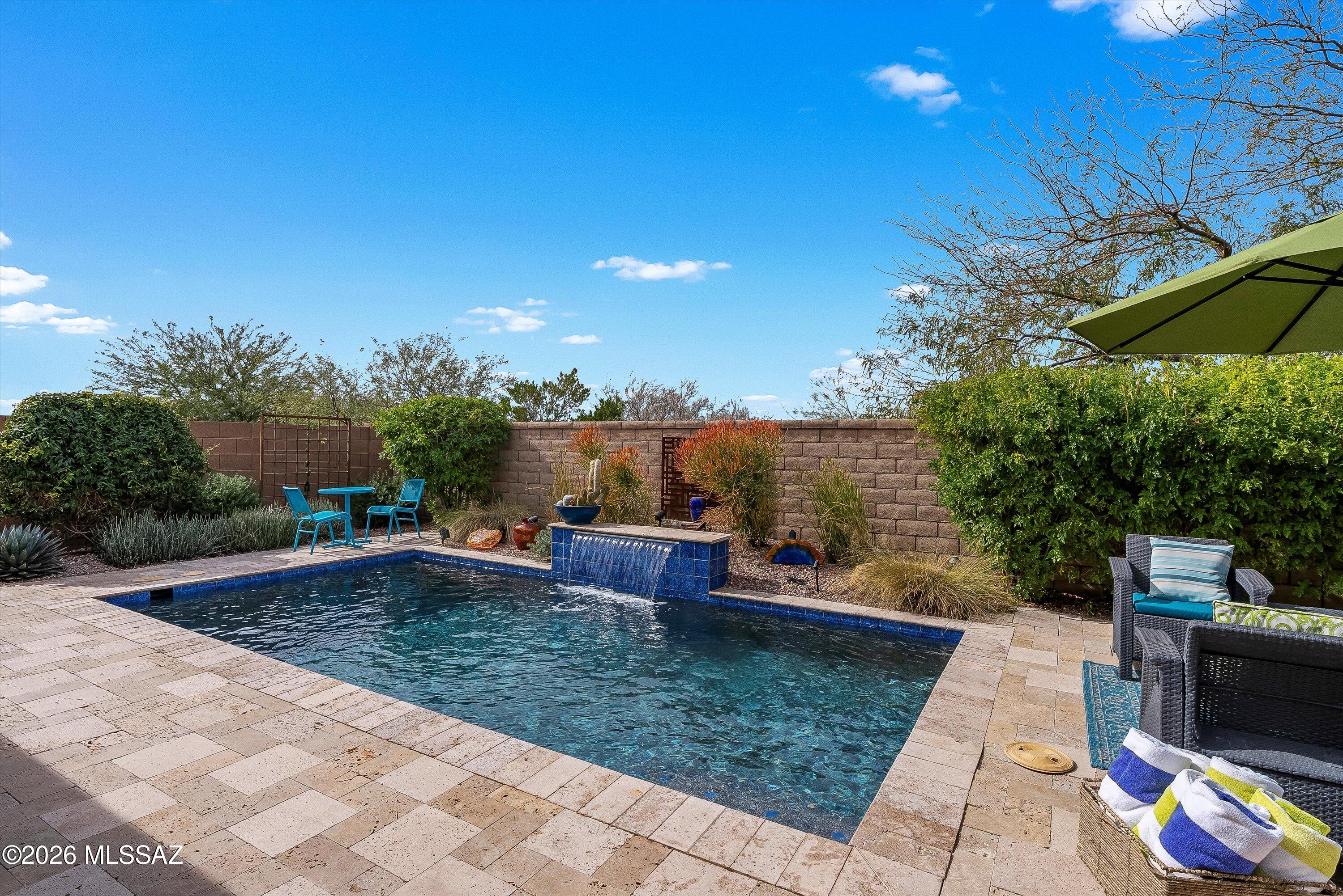 Welcome to this meticulously maintained Haven model offering 1,859 sq ft with 2BR/2.5BA/DEN and owned solar system. The open concept layout features a light-filled living area with a gas fireplace and sleek kitchen with quartz counters, large island and a striking backsplash. The dining area opens to a private rear garden with a heated pool and fireplace, creating the perfect oasis. Additionally, nearby pocket patio is close to the kitchen and ideal for grilling and outdoor living. A centrally located den provides a flexible space to work or play. Private primary suite is tucked at the rear of the home with a spa-like ensuite with a soaking tub and separate shower, while a front guest suite with its own bath offers comfort and privacy.Private rear yard with no neighbors behind the home.