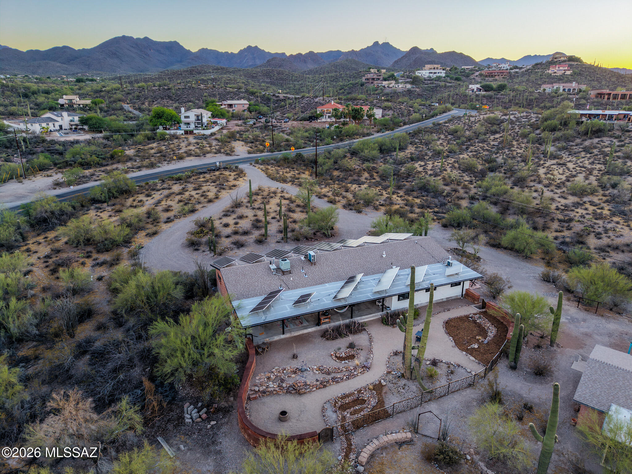 Welcome to your private desert retreat on 3.21 acres with breathtaking mountain and city-light views, conveniently located near Gates Pass, fully paid-off solar, and no HOA. This exceptional property offers the perfect combination of sustainable living, privacy, and modern comfort. The beautifully remodeled 2,292 sq. ft. main residence features 4 bedrooms, 3 full bathrooms, and two private en-suites, each with its own entrance, making them ideal for guests, multigenerational living, or a home office. The open-concept floor plan creates an inviting space for entertaining and everyday living, while the kitchen is equipped with appliances that are less than a year old. Three newly remodeled designer bathrooms add a fresh, modern touch throughout the home. A standout feature of this property is the 100% owned and paid-off solar system. The solar system powers both the main home and the 768 sq. ft. guest house, resulting in little to no electric bill. The current owners report that the system consistently produces more energy than the property consumes, often generating a credit from the utility company. With no gas bill and virtually no energy costs, this carbon-neutral property offers incredible long-term savings and efficiency. The detached guest house includes 1 bedroom, 1 bathroom, a full kitchen, and a washer and dryer hookup, providing excellent flexibility for guests, extended family, rental income potential, or a private workspace. Outside, you'll discover a true desert oasis. The property includes horse fencing and a chicken coop, a greenhouse with electricity, and numerous walking paths throughout the acreage. Relax around the fire pit, gather with friends in the outdoor seating area, or enjoy the newly installed designer backyard gate that enhances both beauty and functionality. Watch spectacular sunsets as the mountains change colors and the city lights begin to twinkle below.Enjoy the hiking and biking trails, this one-of-a-kind property offers the serenity of country living while remaining close to Tucson amenities. Experience sustainable luxury, unmatched views, and endless possibilities in this extraordinary desert estate.

Please see the Documents tab for a complete list of upgrades and improvements.