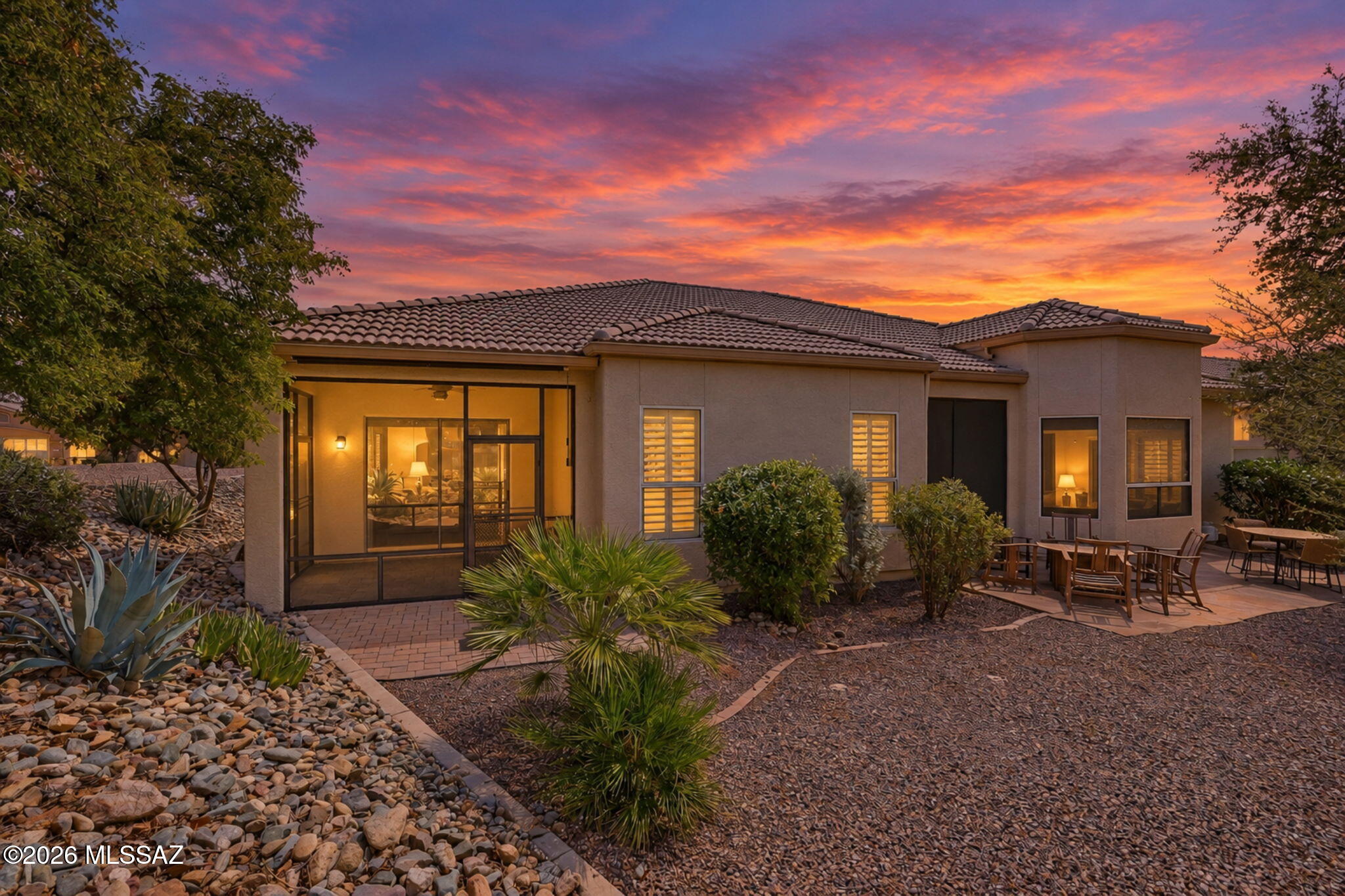 Embrace effortless Sonoran Desert living in this beautifully appointed San Remo Villa, set on a generous lot with a private-feeling backyard, no neighbors behind, and beautiful sunset views. Thoughtfully designed interiors feature  Alderwood cabinetry with pull-outs, quartz countertops, stainless appliances, and travertine flooring. Upgraded lighting, ceiling fans, shutters throughout, and a patio sunscreen add comfort and style. The fully screened back patio extends to additional paver patio and leads to a peaceful sitting area beneath mature trees--an inviting setting for morning coffee and simply enjoying the outdoors. Abundant storage, a 2022 HVAC, a 2022 water heater, and an HOA-replaced roof in 2023 add peace of mind. Enjoy the beauty, privacy, and ease of SaddleBrooke villa living