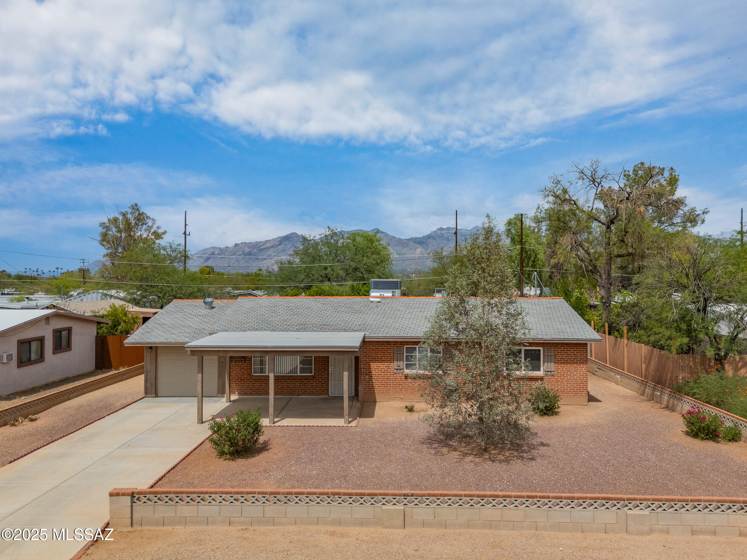 Range priced $300,000-$310,000. Welcome to this well-kept 3-bedroom, 3-bathroom home in central Tucson! A spacious covered front porch invites you inside, where you'll find a bright living room and a separate family room, perfect for entertaining or relaxing. The kitchen offers ample cabinet space, a tasteful backsplash, appliances, and a cozy dining nook. The primary suite includes a generous walk-in closet, ensuite bath with tiled walk-in shower, dual linen closets, and a makeup counter. Tile flooring runs throughout the home for easy maintenance. Enjoy the large backyard with a covered patio, fruit trees, double gate access, pavers, and a storage shed. A 1-car garage with attic access plus washer and dryer complete this move-in ready property in a prime location!