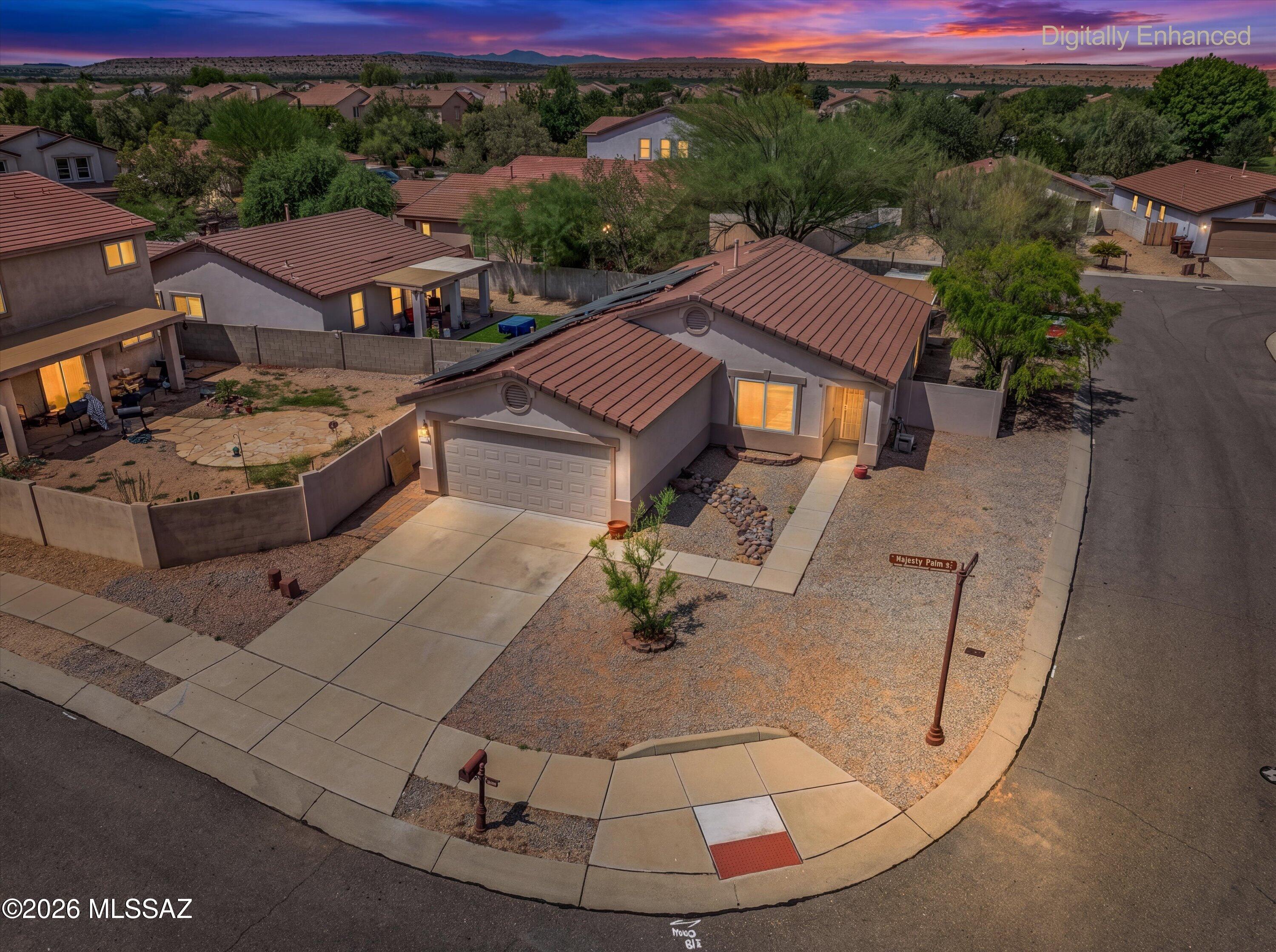 Assumable 3% VA Loan! This move-in-ready home in the award-winning Rancho Sahuarita community checks all the boxes! Enjoy lower energy costs with owned solar, a new AC system and new windows. The desirable corner lot offers added privacy, while the upgraded backyard features an extended covered patio, artificial turf, pavers and a sunshade canopy. Inside, you'll find a spacious kitchen with stainless steel appliances, a gas range and island. The refrigerator, washer and dryer stay with the home! The interior offers 3 bedrooms, an office and no carpet. The garage is equally impressive with epoxy flooring, a utility sink and built-in shelving. Enjoy Rancho Sahuarita's resort-style amenities, including a clubhouse, water park, pools, parks, trails, fitness facilities and a 10-acre lake.