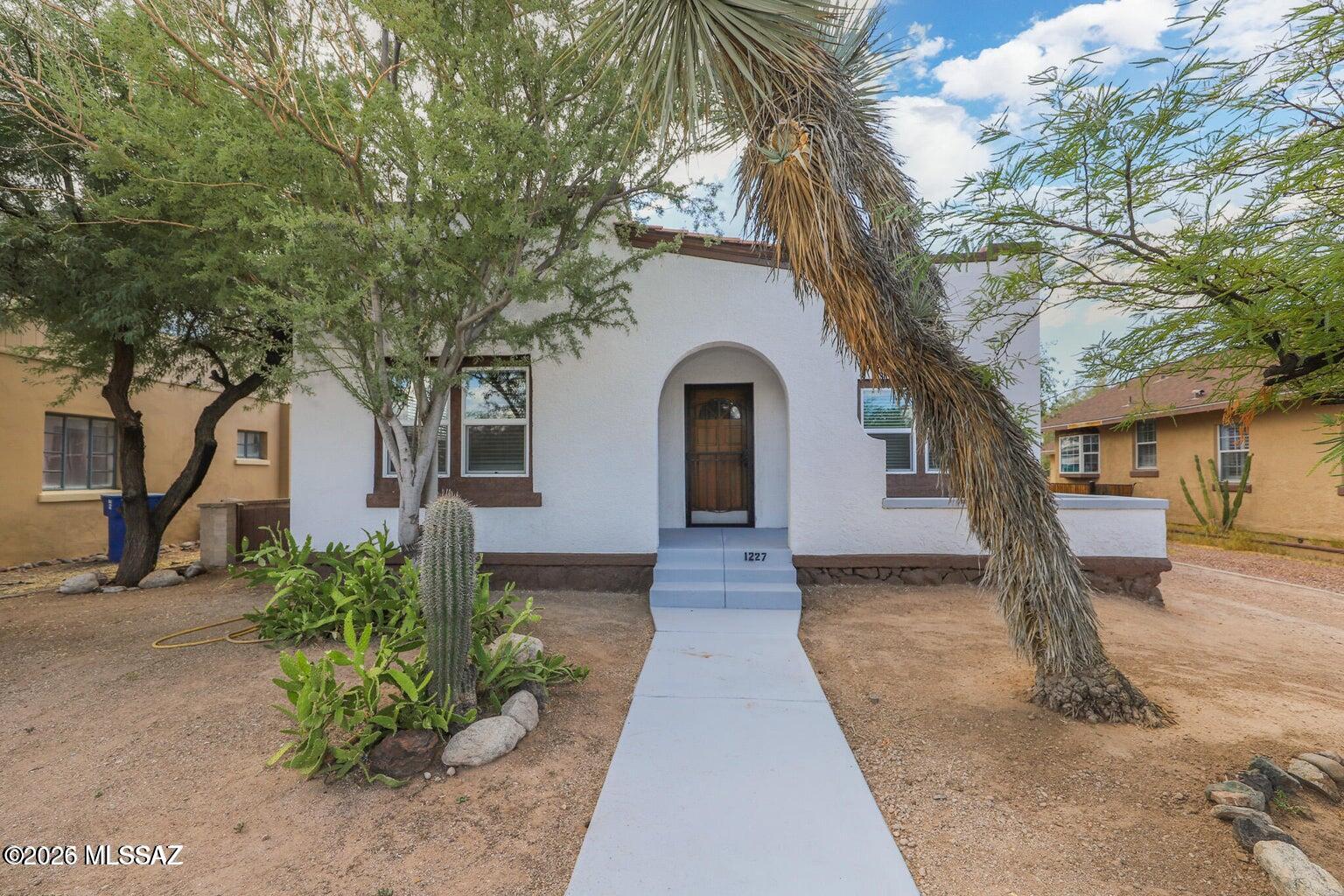 Charming historic property in the desirable Feldman's neighborhood near the University of Arizona, 4th Avenue, and downtown.  The updated main home features 4 bedrooms and 2 baths with modern upgrades while preserving the classic character.  A detached 2-bedroom guesthouse with private entrance and alley access offers excellent rental or multi-generational living opportunities.  Spacious lot, outdoor living areas, and a prime central location make this a fabulous find!