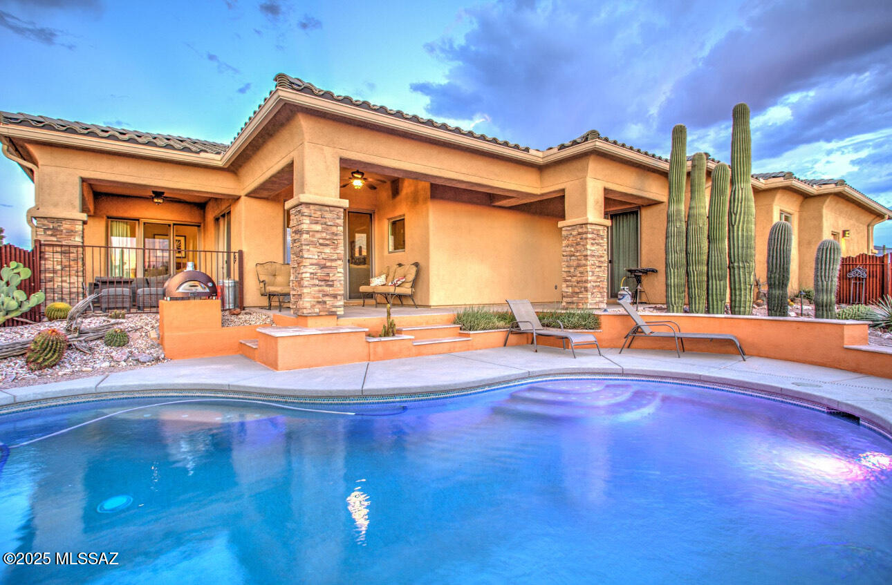 Experience the best of desert living in this meticulously maintained 3-bedroom, 2 1/2 -bathroom Southwestern-style retreat, set on 3.63 acres of pristine land. Built in 2016, this 1,864 sq. ft. residence blends comfort, style, and functionality with panoramic views of the surrounding mountains and desert landscape. Behind a private gated entry, the property features an impressive horse setup complete with a 4-stall barn, tack room, and turnouts, ideal for equestrian enthusiasts. The home's open-concept floor plan is filled with natural light, high ceilings, and warm ceramic tile flooring that flows throughout the main living spaces. The kitchen is beautifully appointed with granite countertops, stainless steel appliances, and a spacious dining area, perfect for entertaining. The primary suite offers private patio access, an expansive en suite with dual vanities, a walk-in shower, and a generous walk-in closet. The secondary bedrooms are thoughtfully designed, including one with direct patio access and a luxurious copper soaking tub. Step outside to enjoy multiple covered patios, a sparkling salt water pool, and serene mountain vistas, creating the perfect backdrop for outdoor relaxation. Additional highlights include a two-car garage, detached storage building, and inclusion in the sought-after Tanque Verde School District. This exceptional property offers tranquility, space, and proximity to trails and Saguaro National Park East for hiking, biking, and riding. A rare opportunity to own a move-in-ready estate that truly captures the spirit of the Southwest.