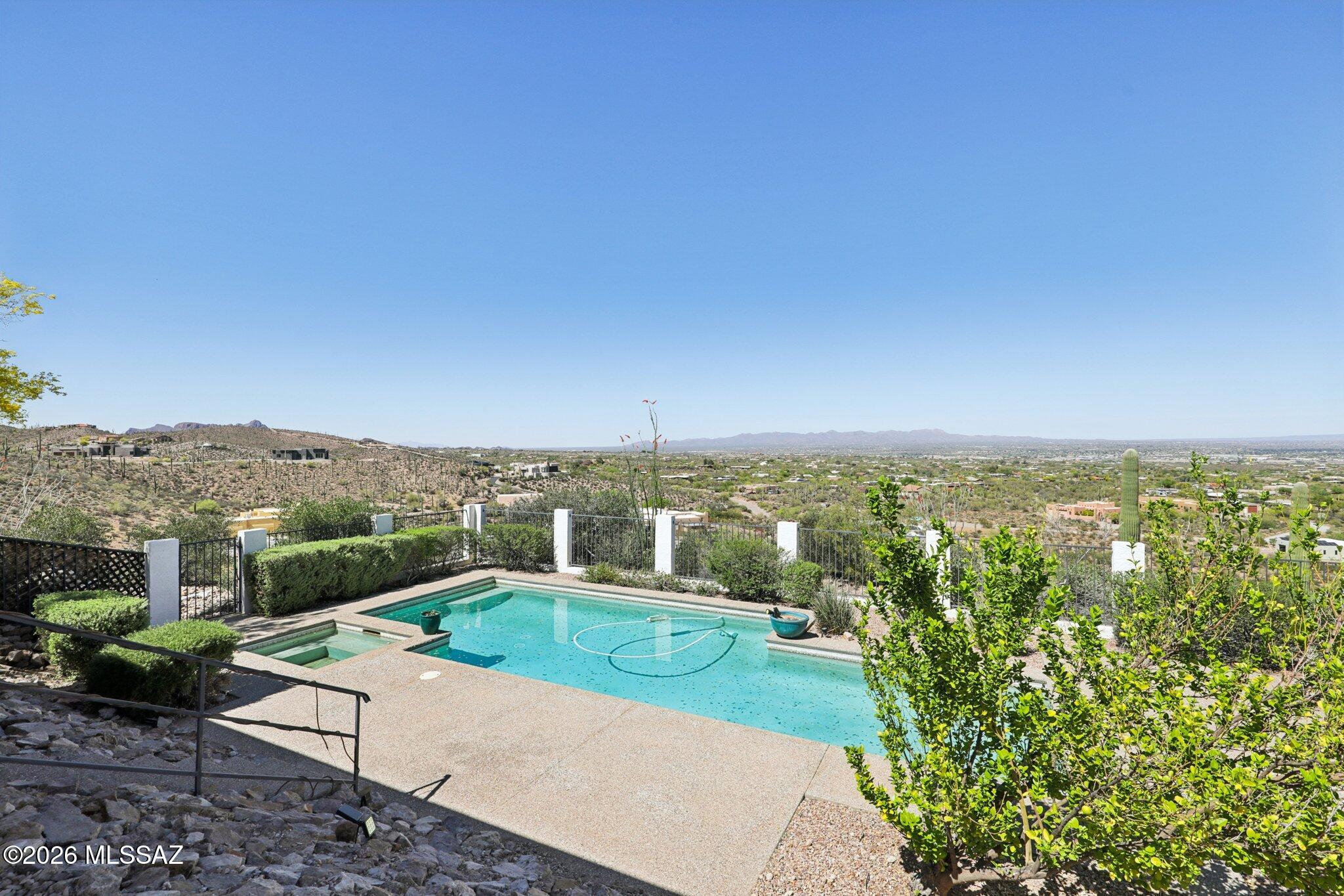 VIEWS like this don't come around often! Perched high in the coveted Tucson Mountain Foothills, this stunning hillside retreat delivers the kind of panoramic views that stop you mid-sentence. Sweeping vistas of the Santa Catalina Mountains, the shimmering Tucson Valley, and the iconic Sonoran Desert are like a painting that changes with every sunrise and sunset. Enjoy nearly 2 full acres of prime elevated terrain, this 3-bedroom, 2 bath offers you a rare combination of seclusion, natural beauty, and zero HOA restrictions giving you the freedom to live entirely on your terms. Step outside and take a swim in your sparkling pool while soaking in the unobstructed mountain and city views. Less than a half mile from the Sweetwater preserve trailhead that consists of 703 acres and 15 trails of saguaro-studded Sonoran Desert for hiking, mountain biking, and dog walking, right out your door. Just 
minutes from Saguaro National Park's Tucson Mountain District and Tucson Mountain Park. Easy access to the iconic Gates Pass scenic corridor and close to Tucson's west-side amenities while feeling completely away from it all. If you want to own a home where the views are priceless and the location is unbeatable then call and schedule your private tour today!